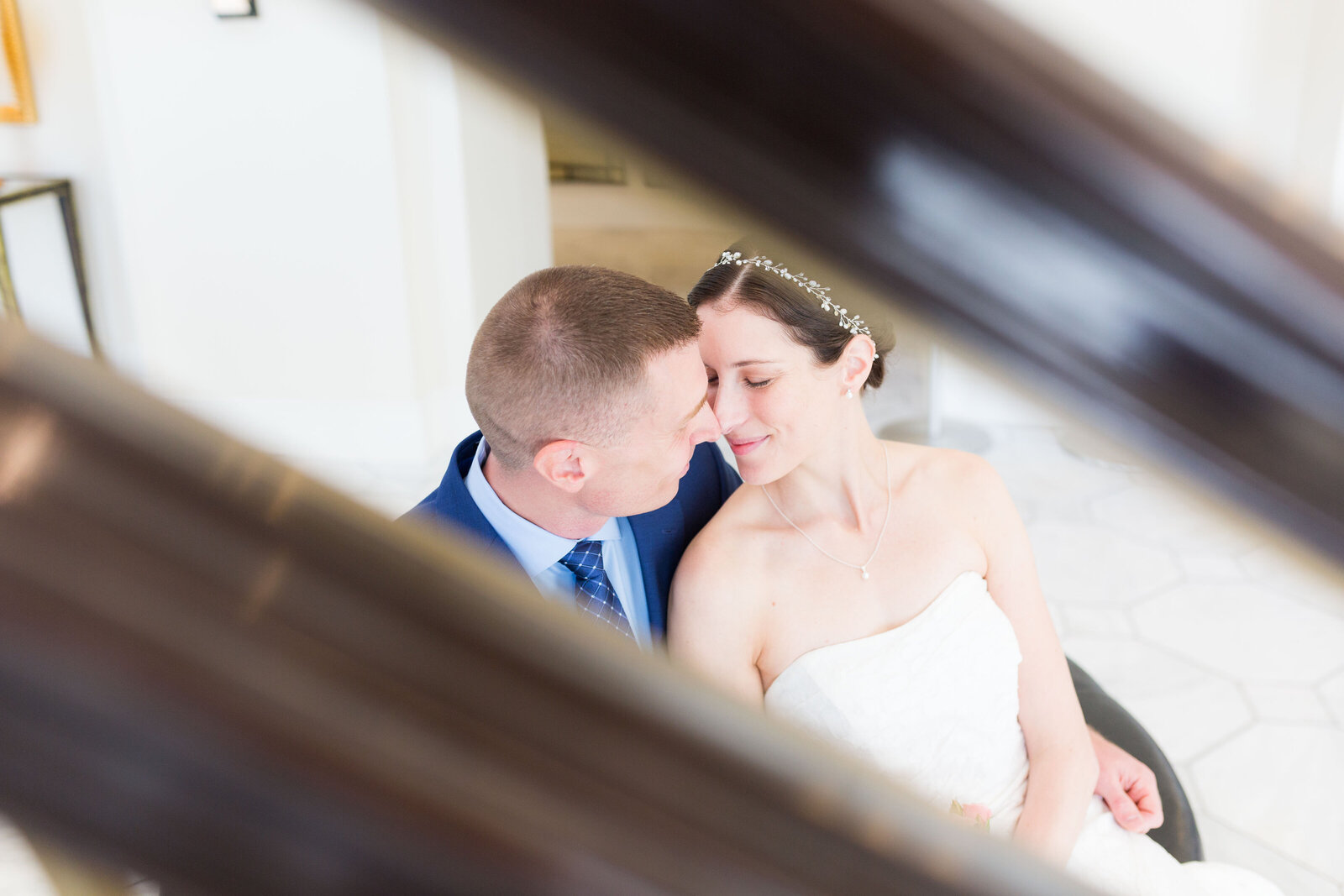 bride and groom snuggle as seen through staircase- Hotel Blackhawk