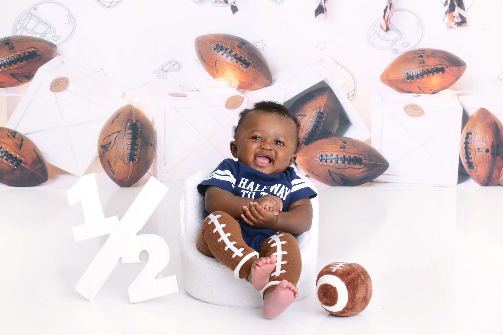 boy smiles at his half football photoshoot