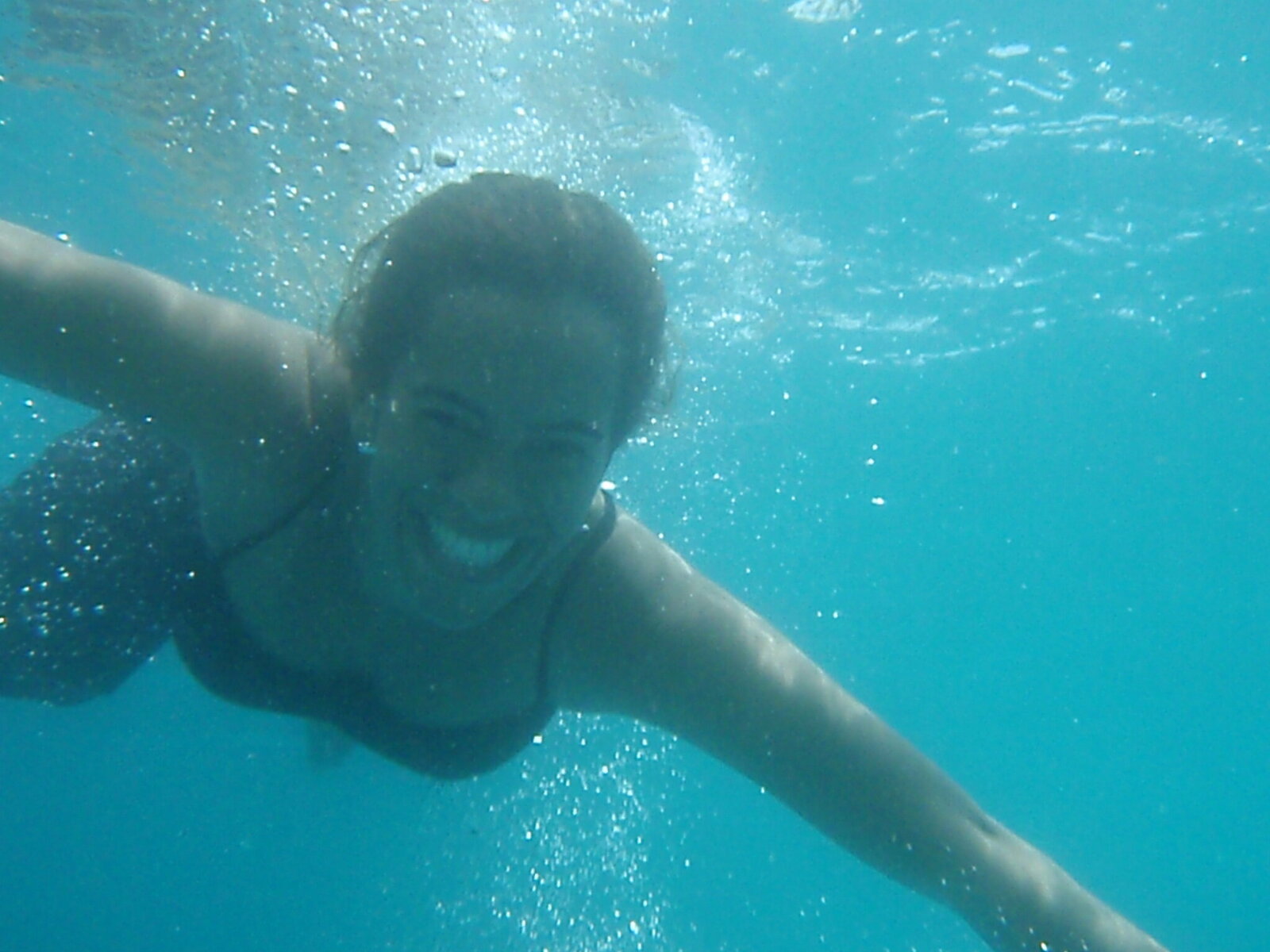 Myrna smiling under water.