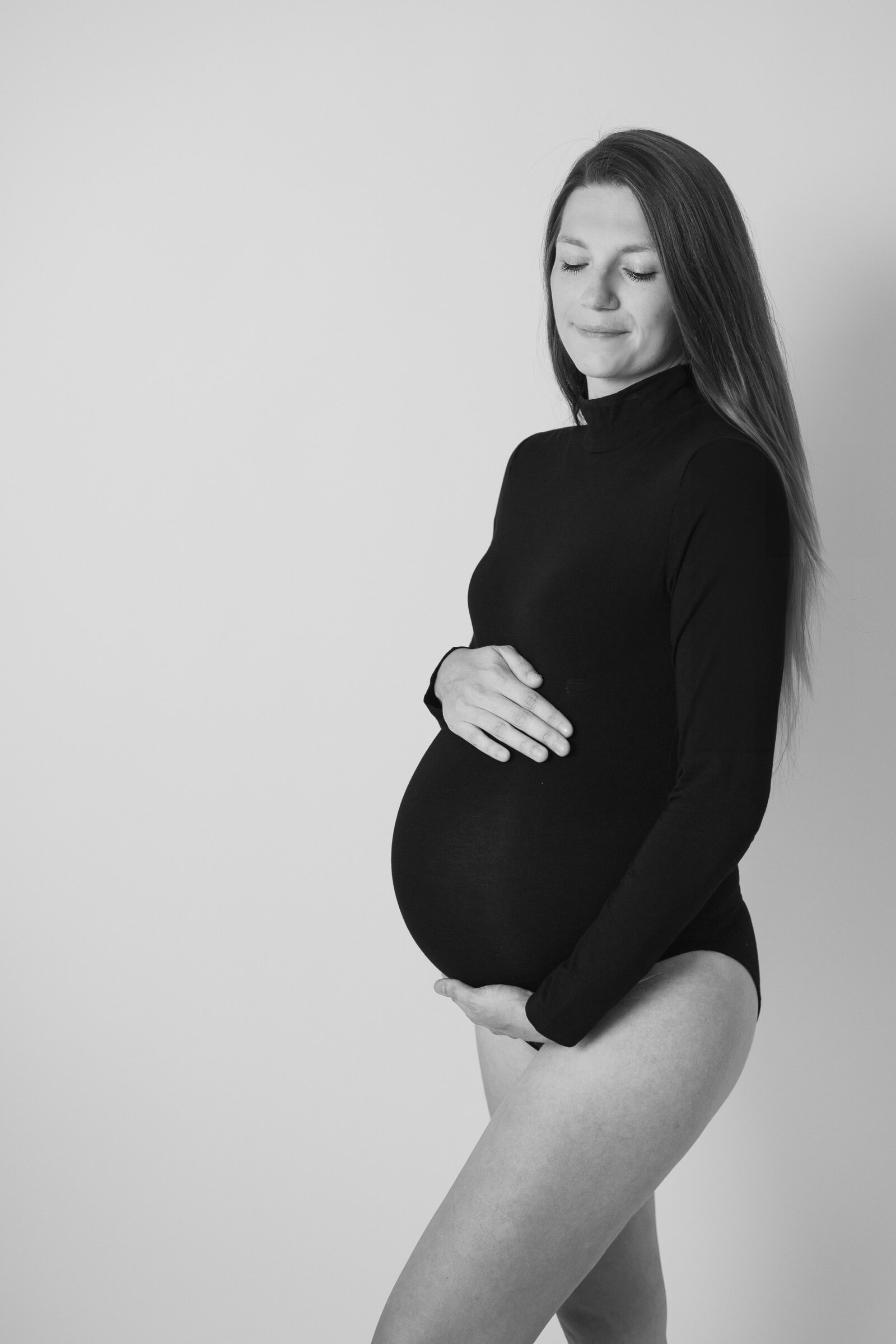woman in black body suit for a maternity photoshoot