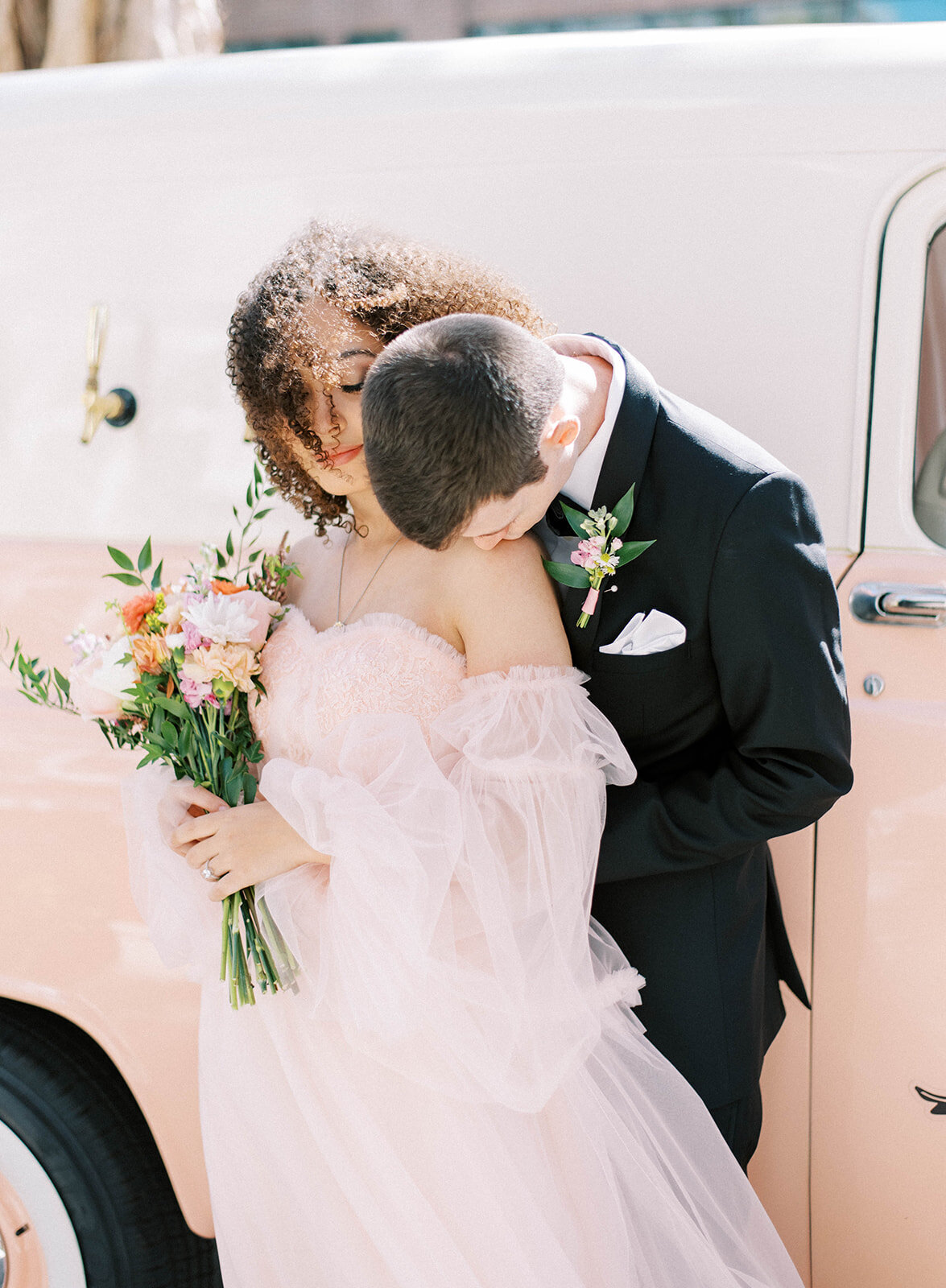 groom kissing bride's shoulder during bridal portraits in Tampa Florida