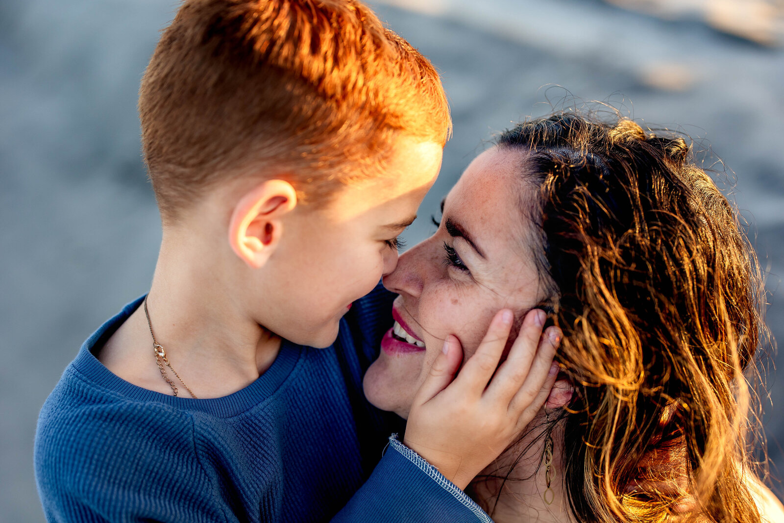 Young boy caressing mother's face on the beach in Wildwood Crest, New Jersey