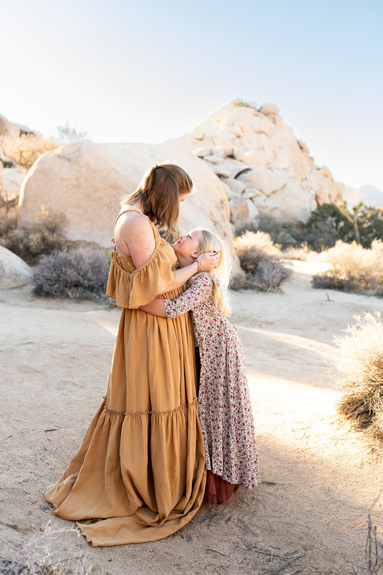 Mom and daughter looking at one another a beautiful Joshua Tree photo spot.