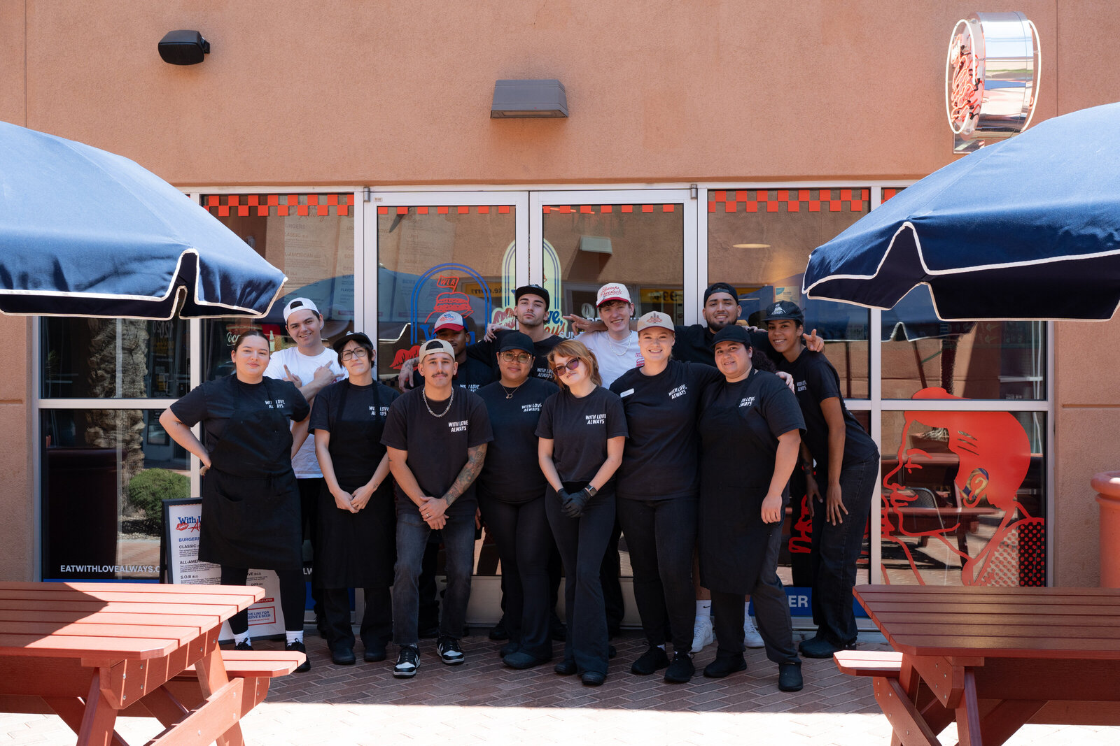 With Love, Always team members standing in front of the entrance at the Las Vegas location, wearing branded uniforms and apparel