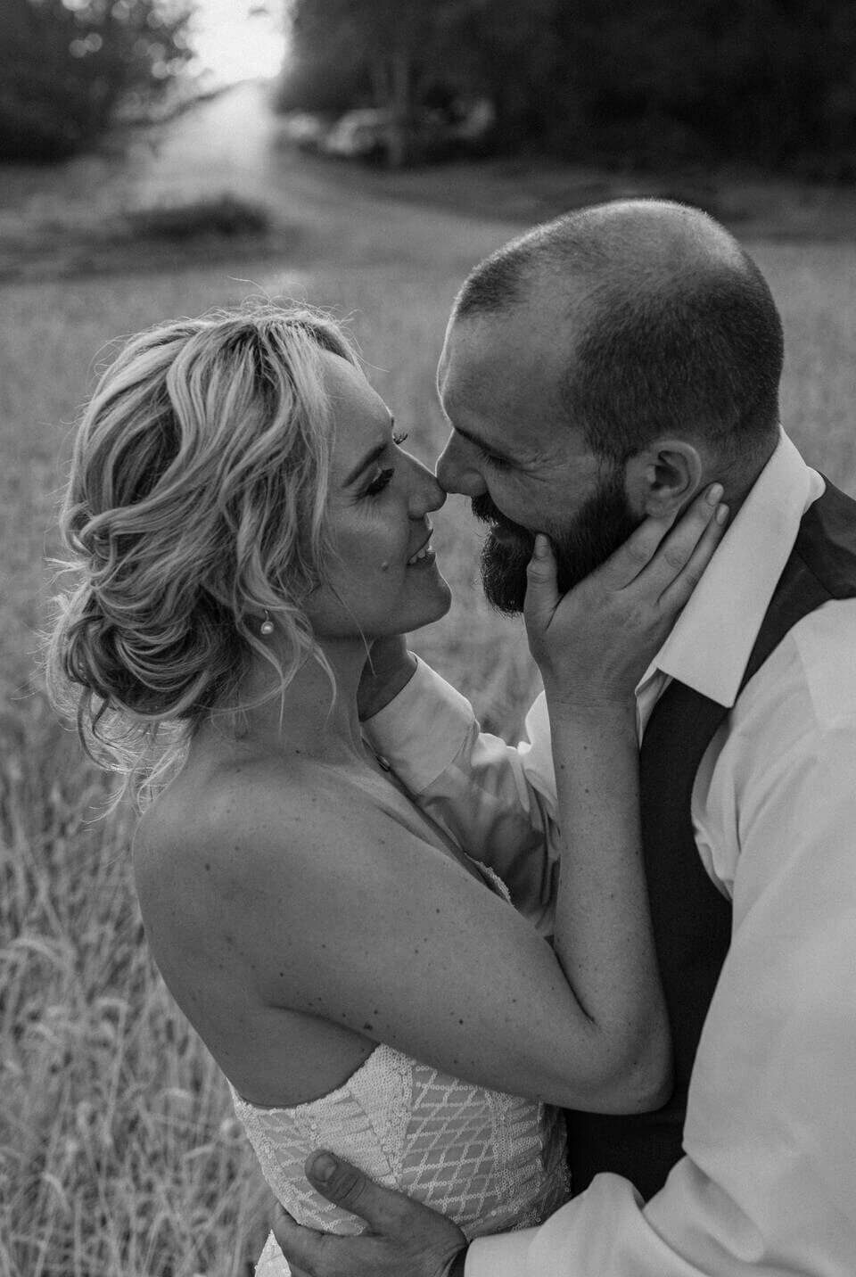 newlywed wedding portrait kissing outside at lavender fields in milton delaware by sabrina leigh