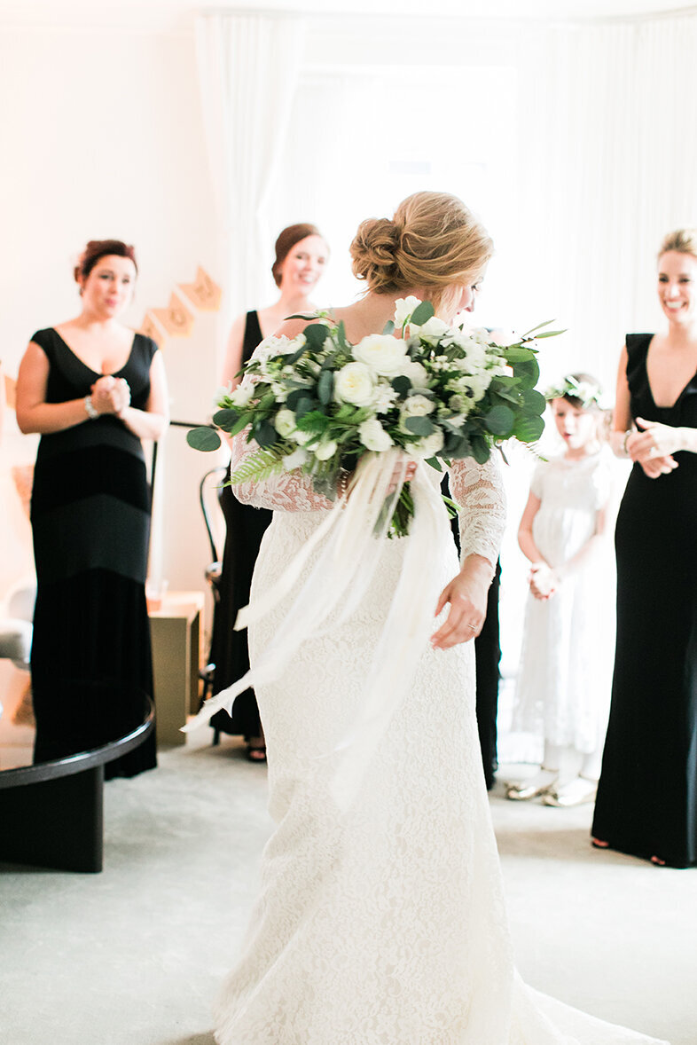 A bride twirls as she reveals her wedding dress to her bridesmaids at the Ambassador Hotel in Chicago, IL.