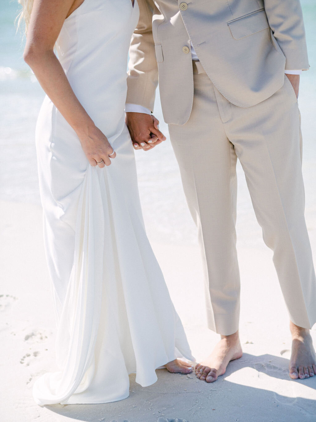 Bride and groom holding hands at destination wedding at Rosemary beach Florida