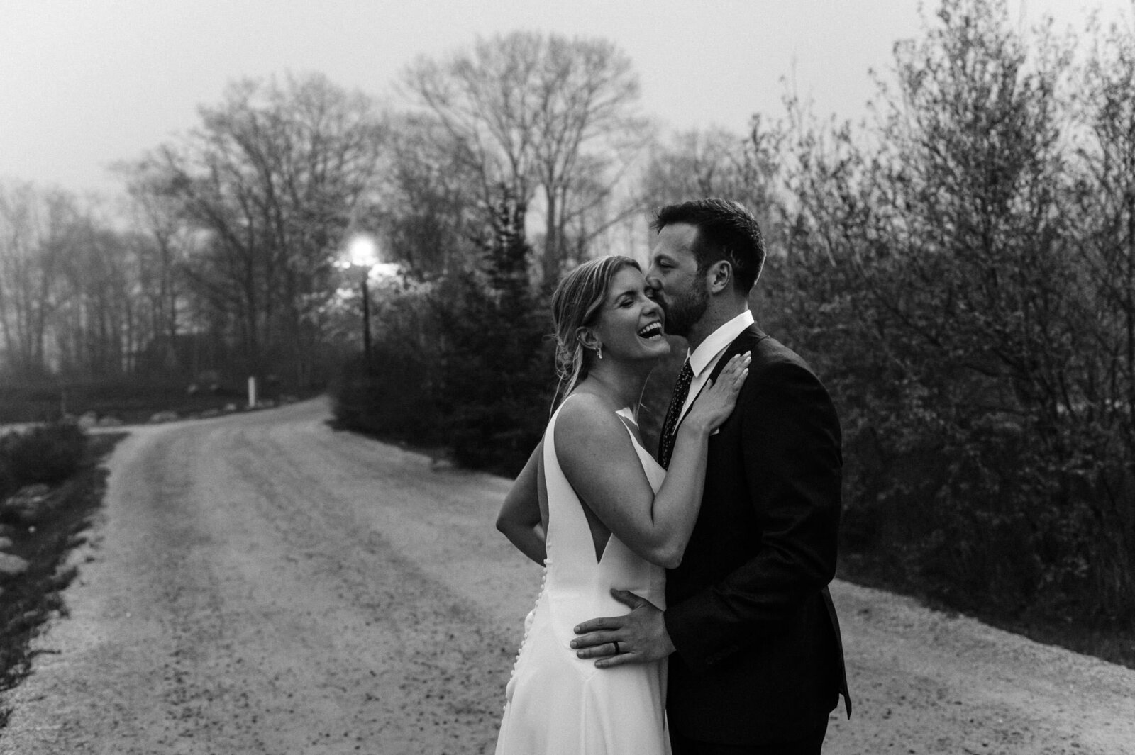 Candid moment of bride and groom standing on the road at fall wedding in Nova Scotia.