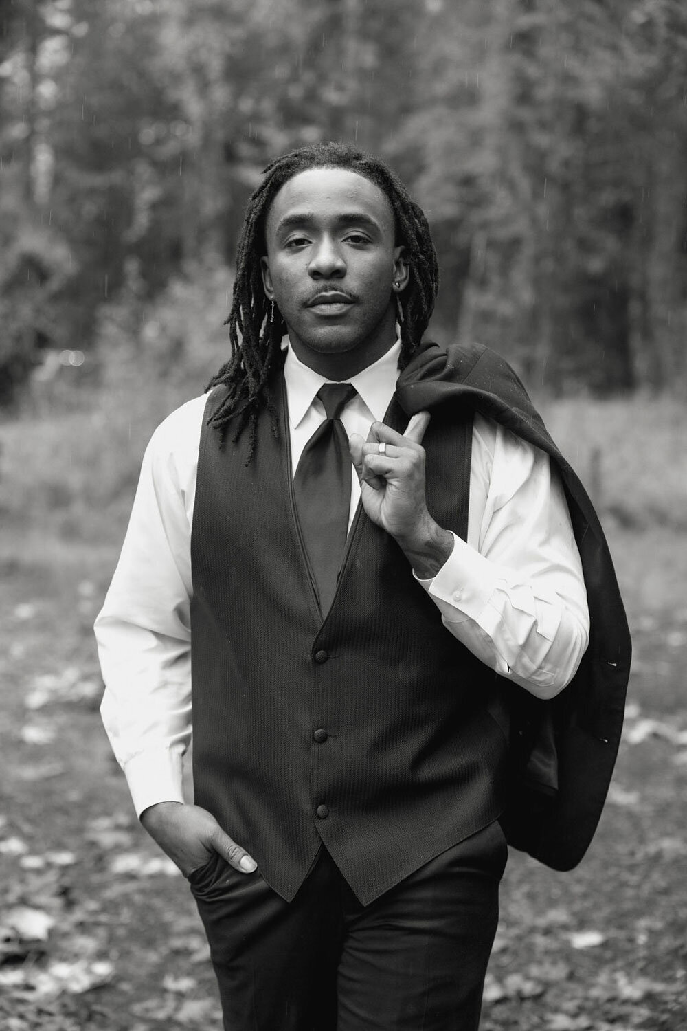 Groom carrying his suit
