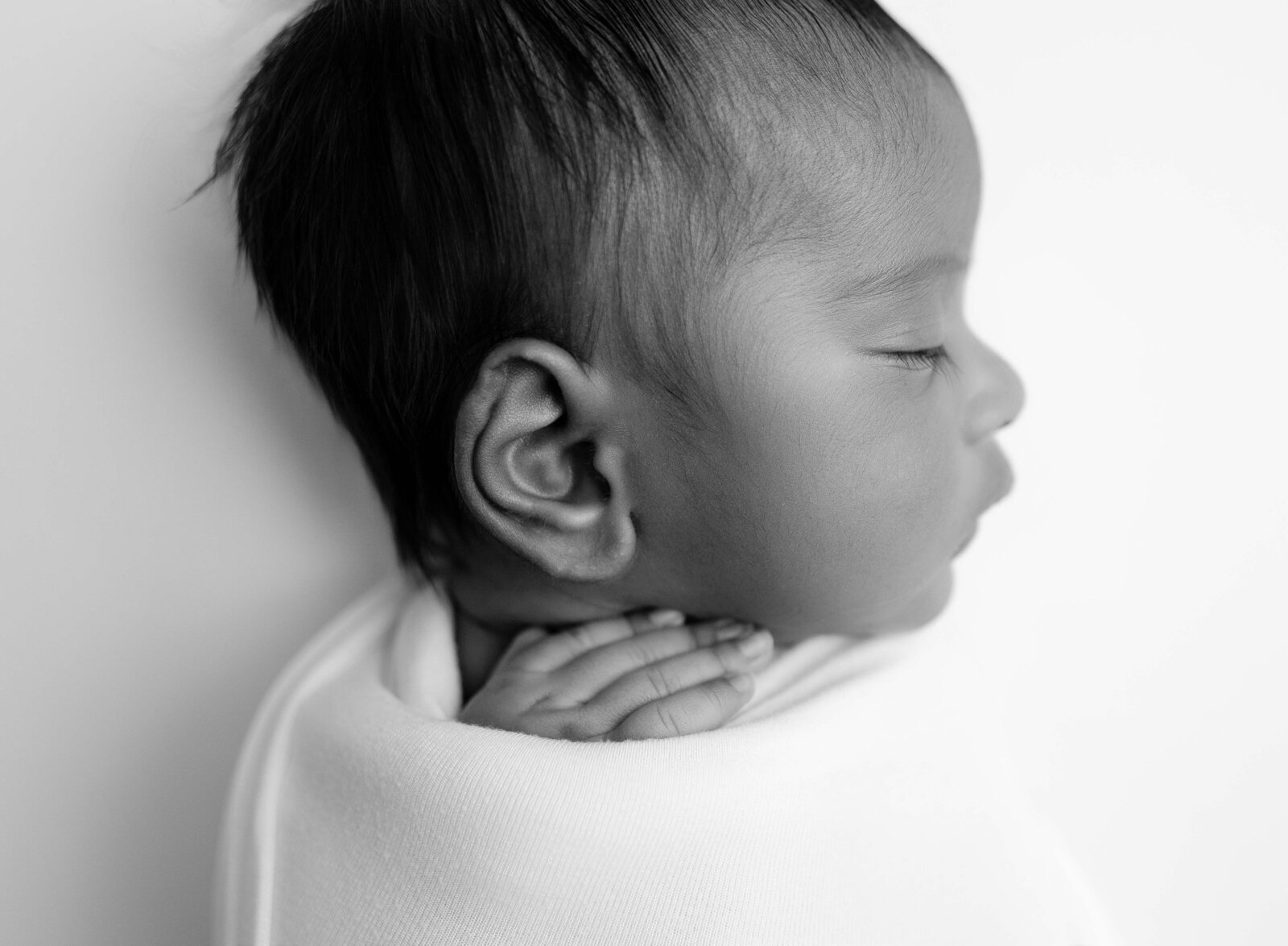 Profile shot of baby's ear details. Newborn Photography session photographed at Jenni Nikki's photo studio in Marietta, GA, near Atlanta.