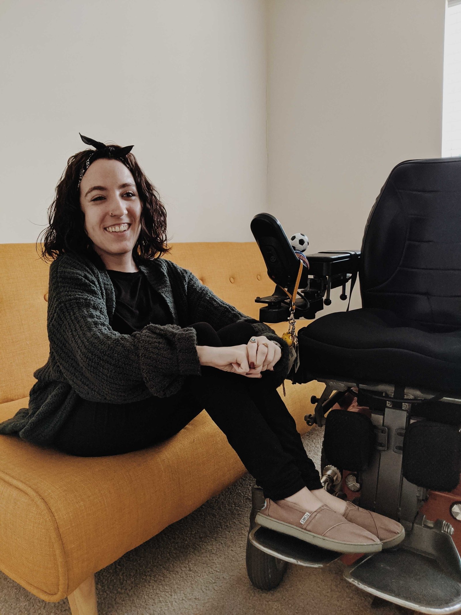 nik sits on a yellow couch