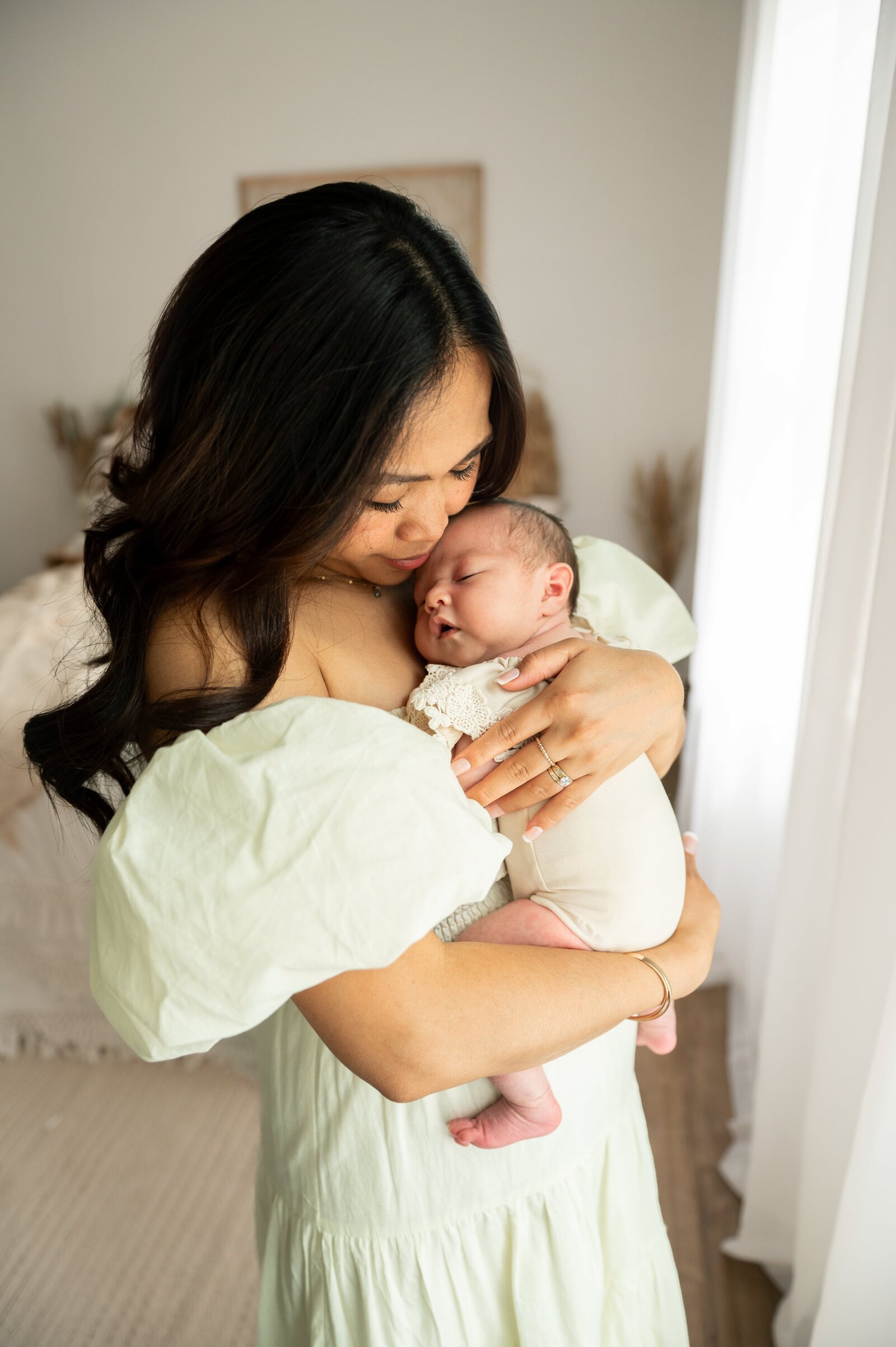 mom holding her 3 week old baby girl