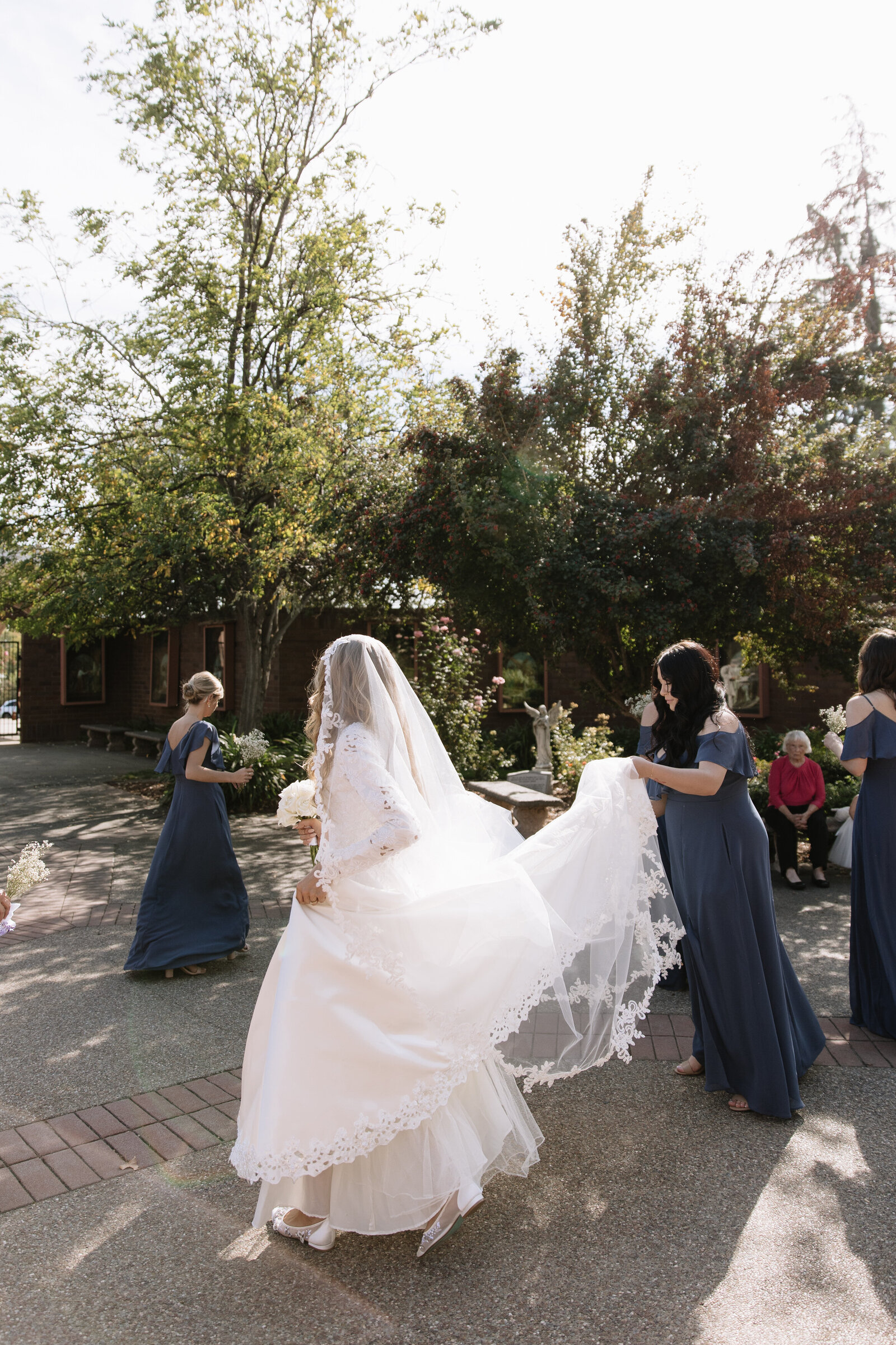 Bridal party holding bride's train and celebrating together after Idaho wedding ceremony
