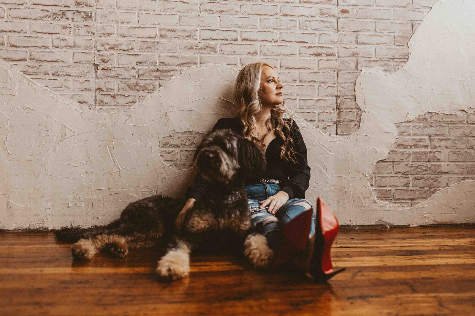 woman sitting on the floor with her dog