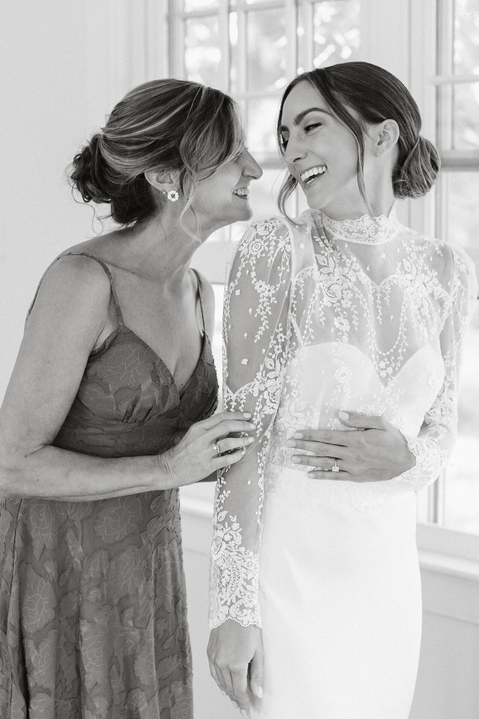 Black and white candid of bride and her mother on the morning of Radnor Hunt wedding. 