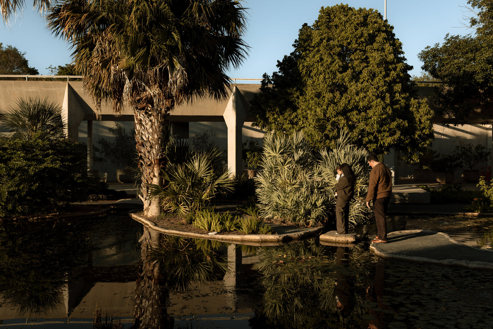 family of three at botanical gardens