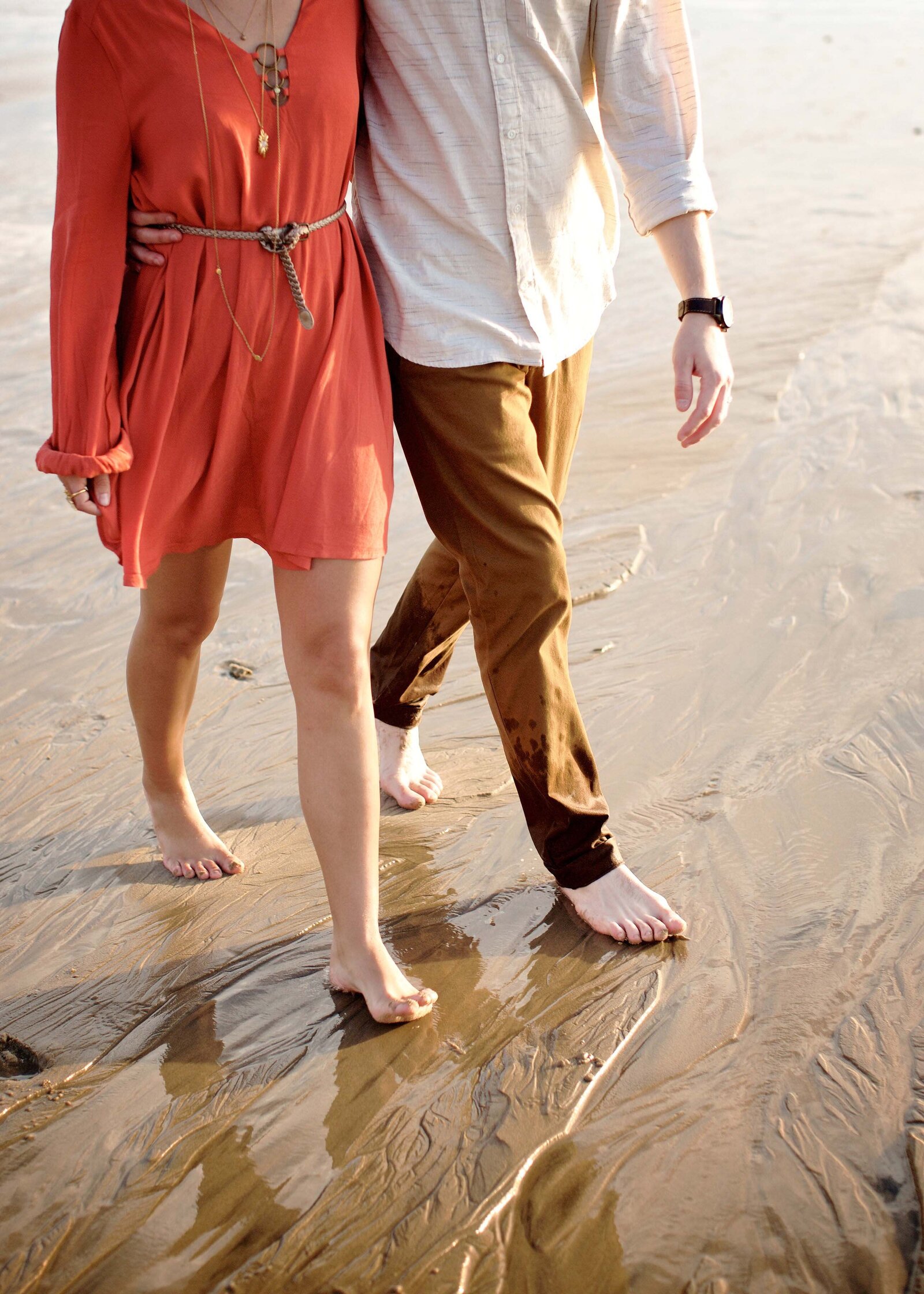 Young Stylish boho hip couple walking on the beach for clothing boutique photographs