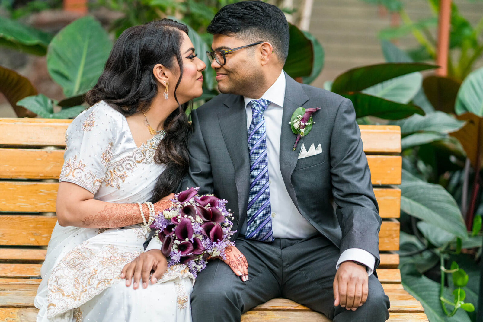 Bride and groom about to go in for a kiss , end up giggling