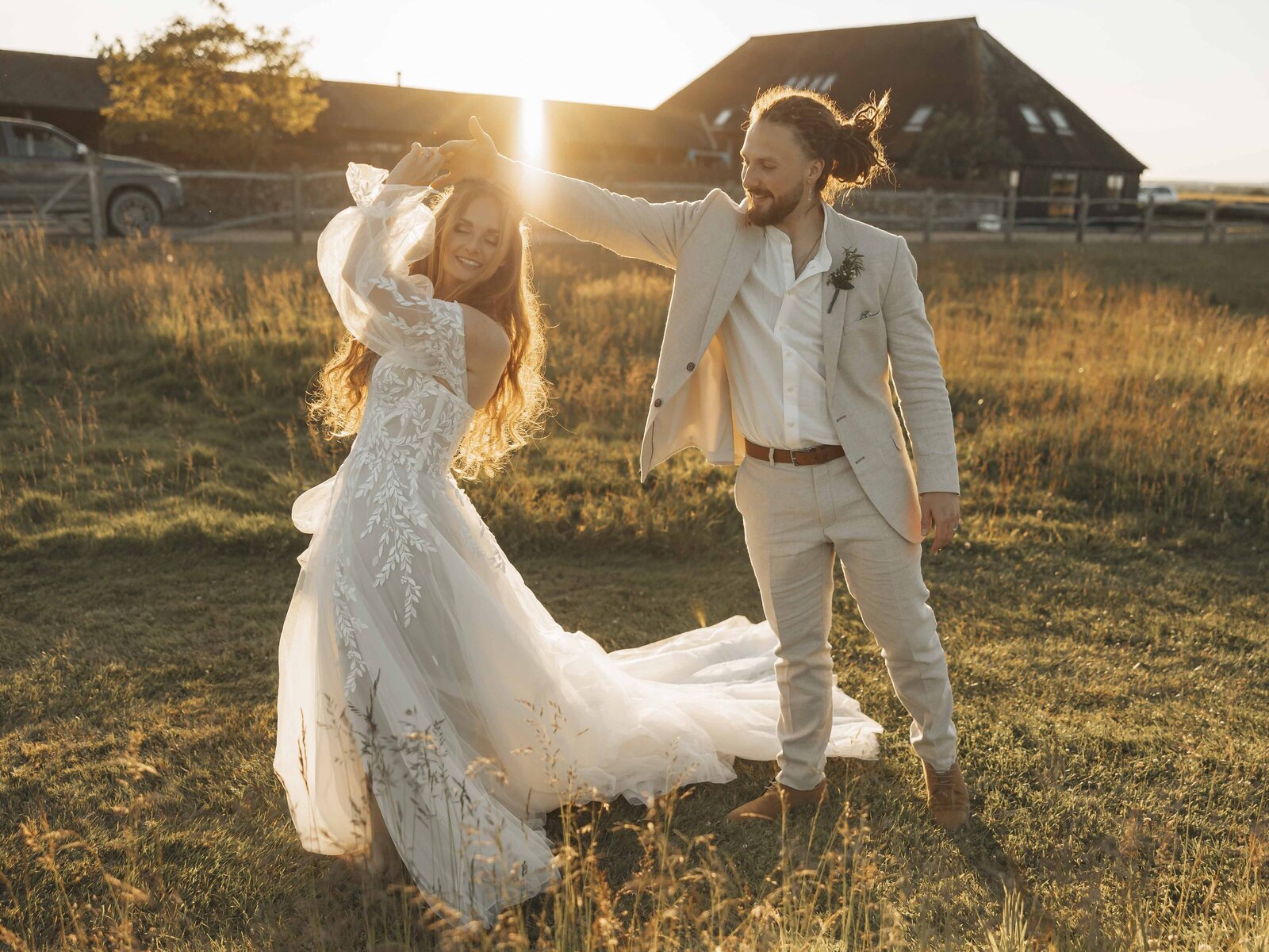 bride and groom dancing in the golden light