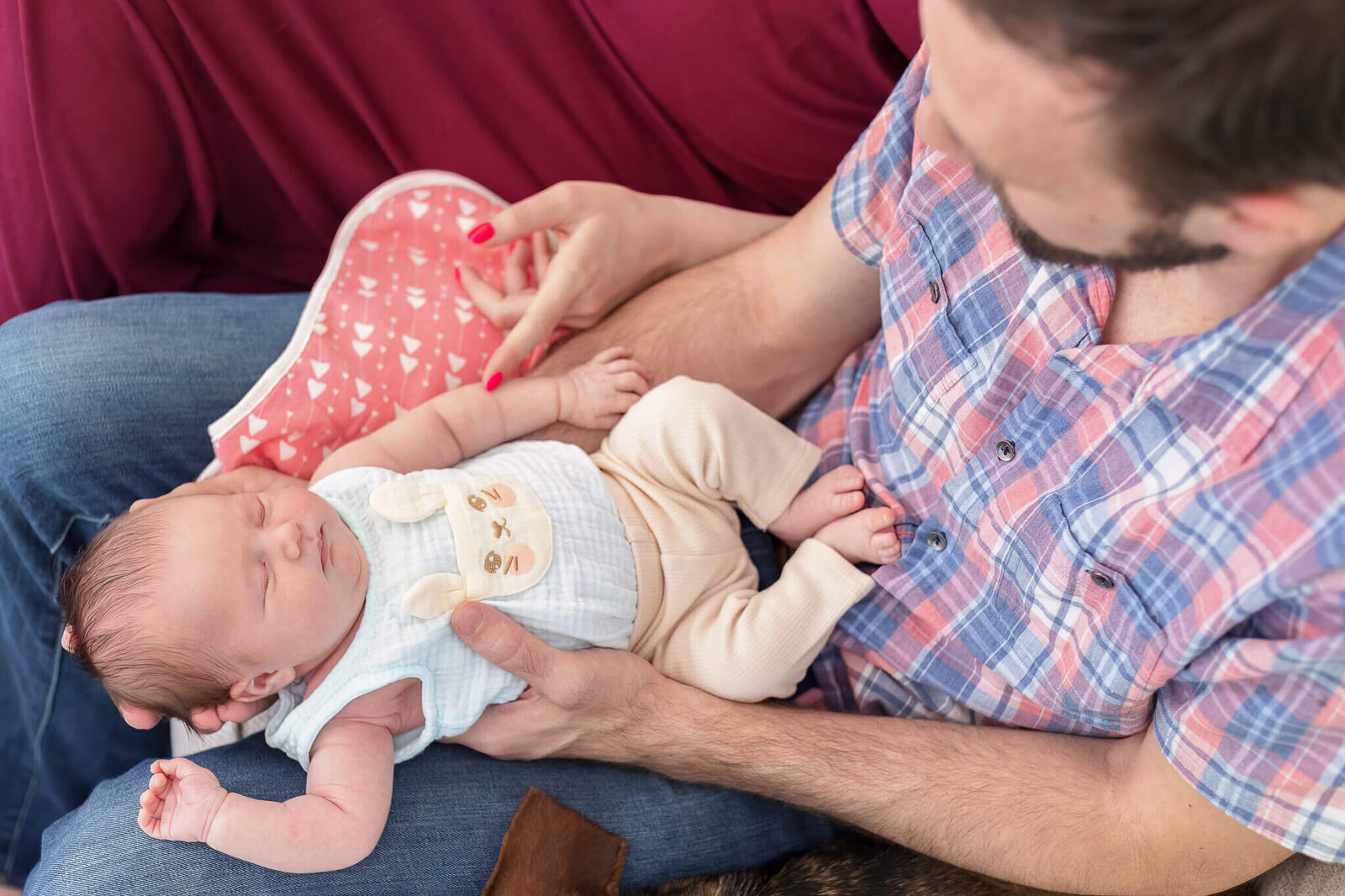 A baby girl being held by her dad.