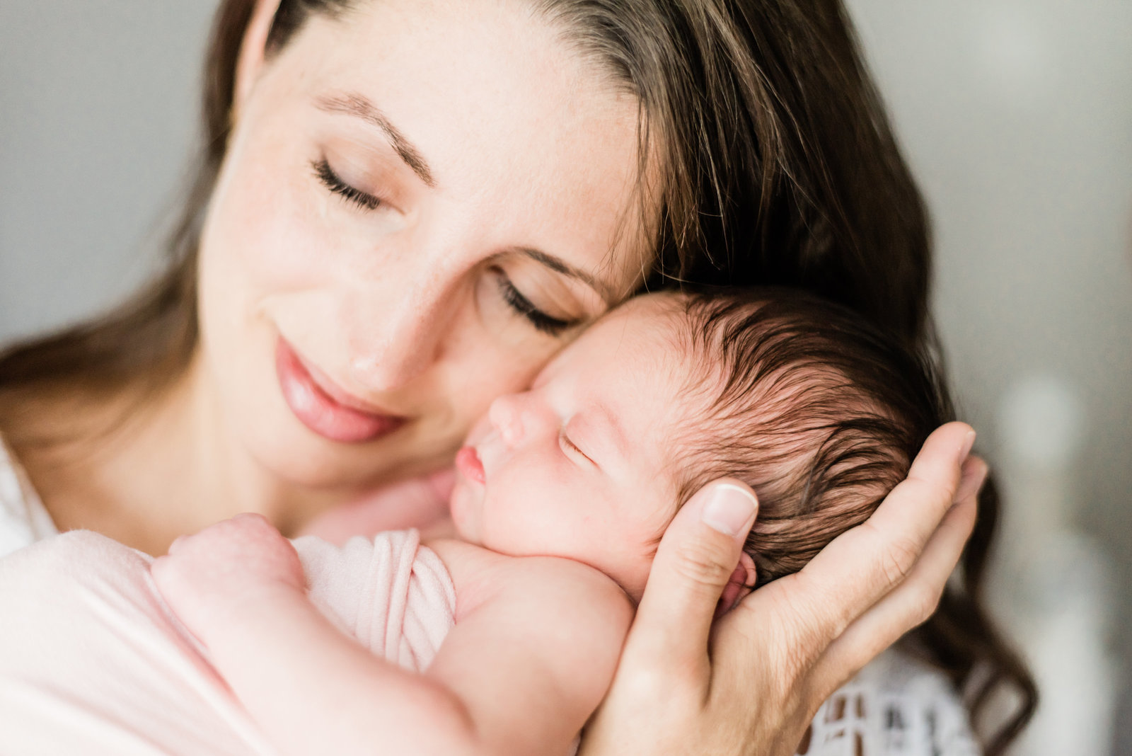 Mom holding baby for lifestyle newborn session