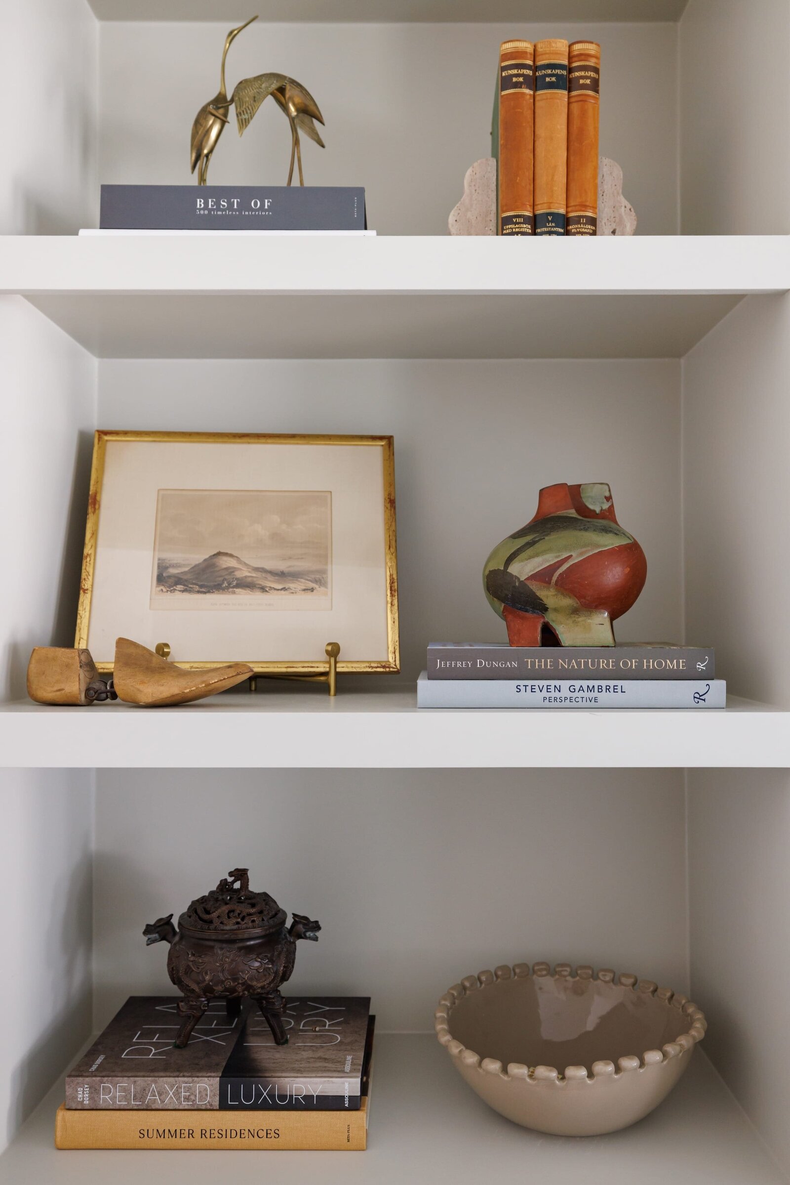 vision and hammer styled shelves with gold photo frame and books