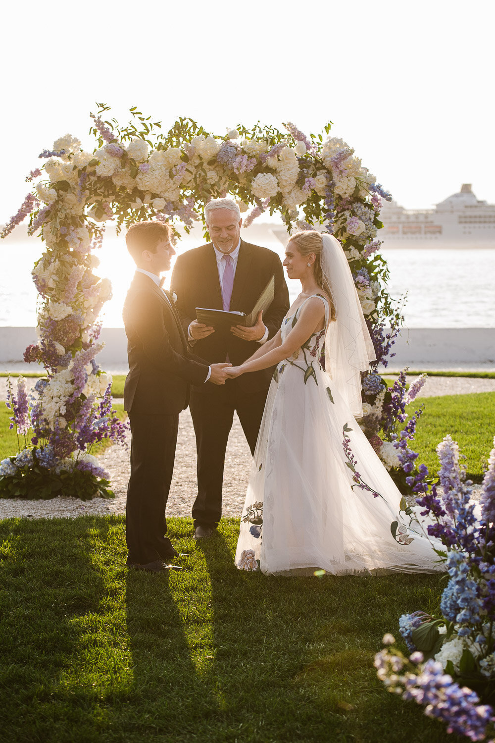 couple at floral alter during vows 