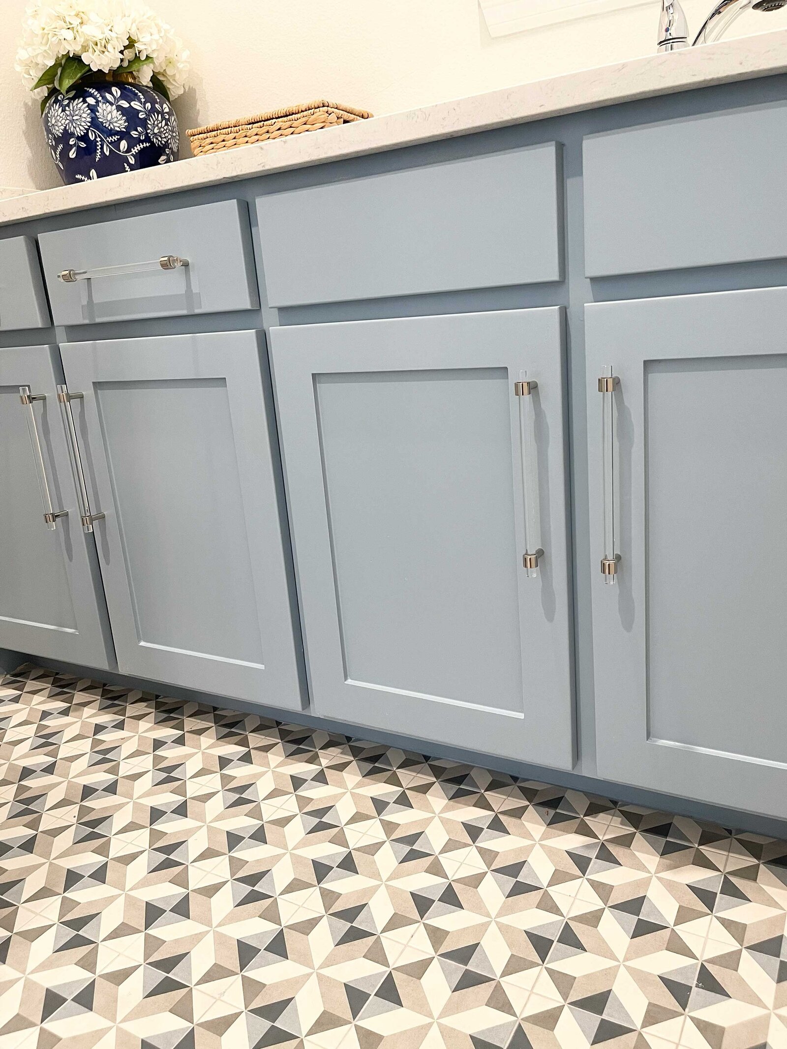 Frisco home design expert showcasing a close-up of aquamarine kitchen furniture, highlighting elegant design and craftsmanship.