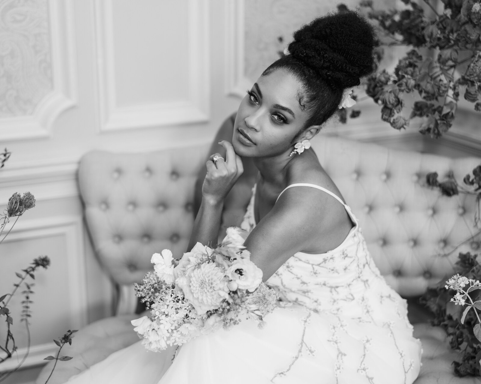 A bride sits on an antique sofa