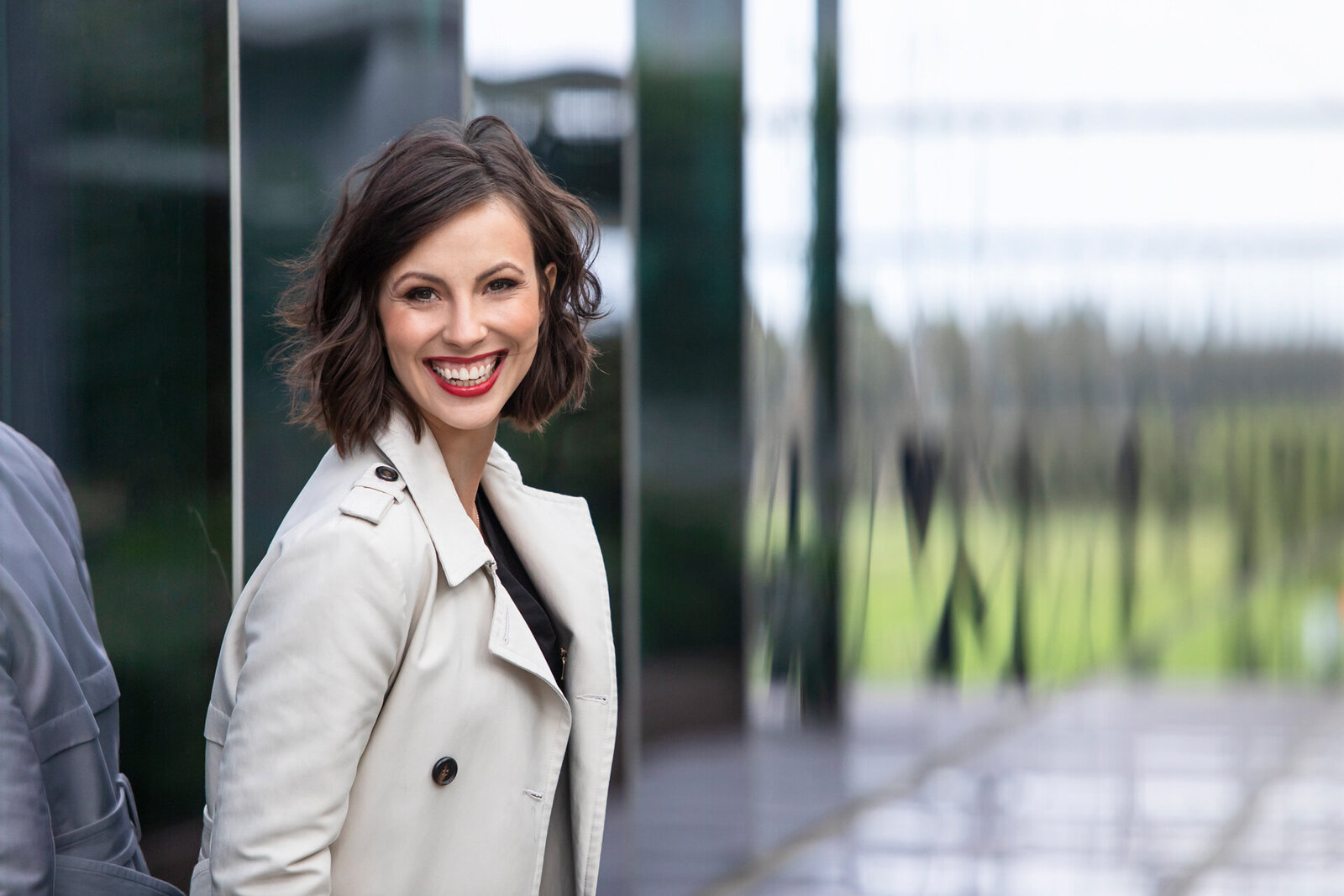 Business woman leaning against a glass wall of a building