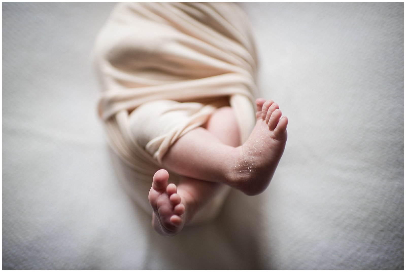 Newborn baby girl swaddled with toes peeking out Emily Ann Photography Seattle Photographer