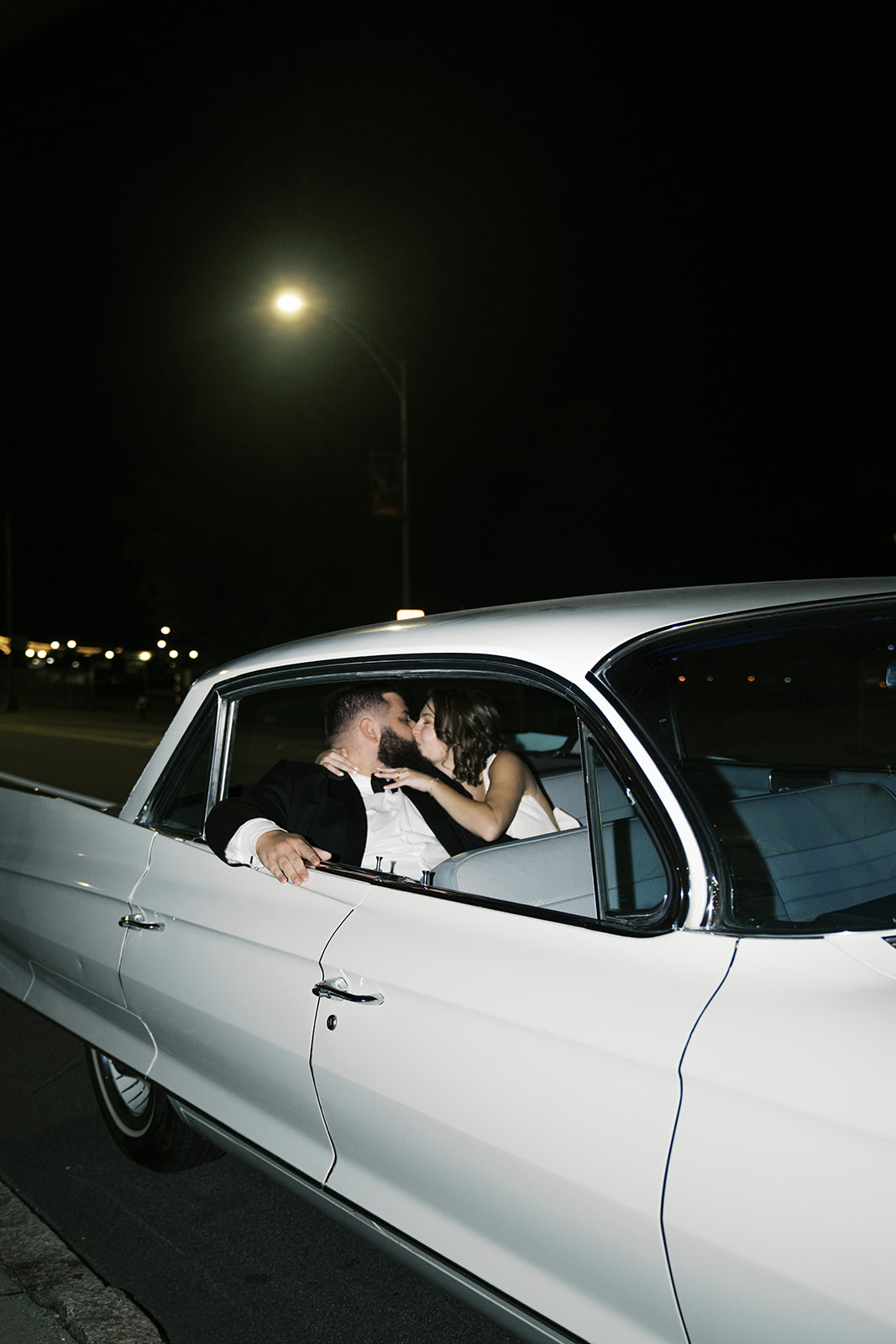 Bride and groom kissing in the back of his wedding car | Megan Smith Photography