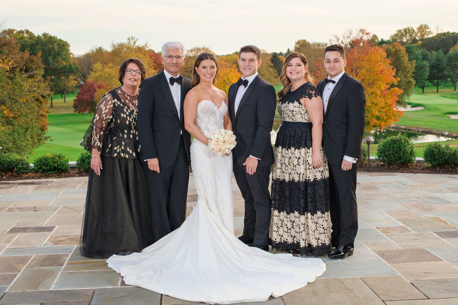 bride and groom with family outside Glen Head Country Club