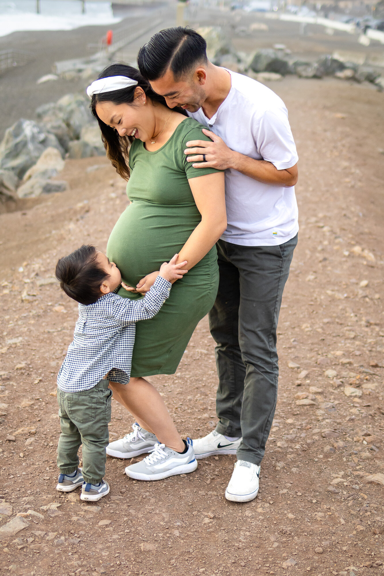 Bay Area Maternity Portfolio - Ellobelle Photography showcasing sweet belly kiss from toddler to pregnant mom near the beach