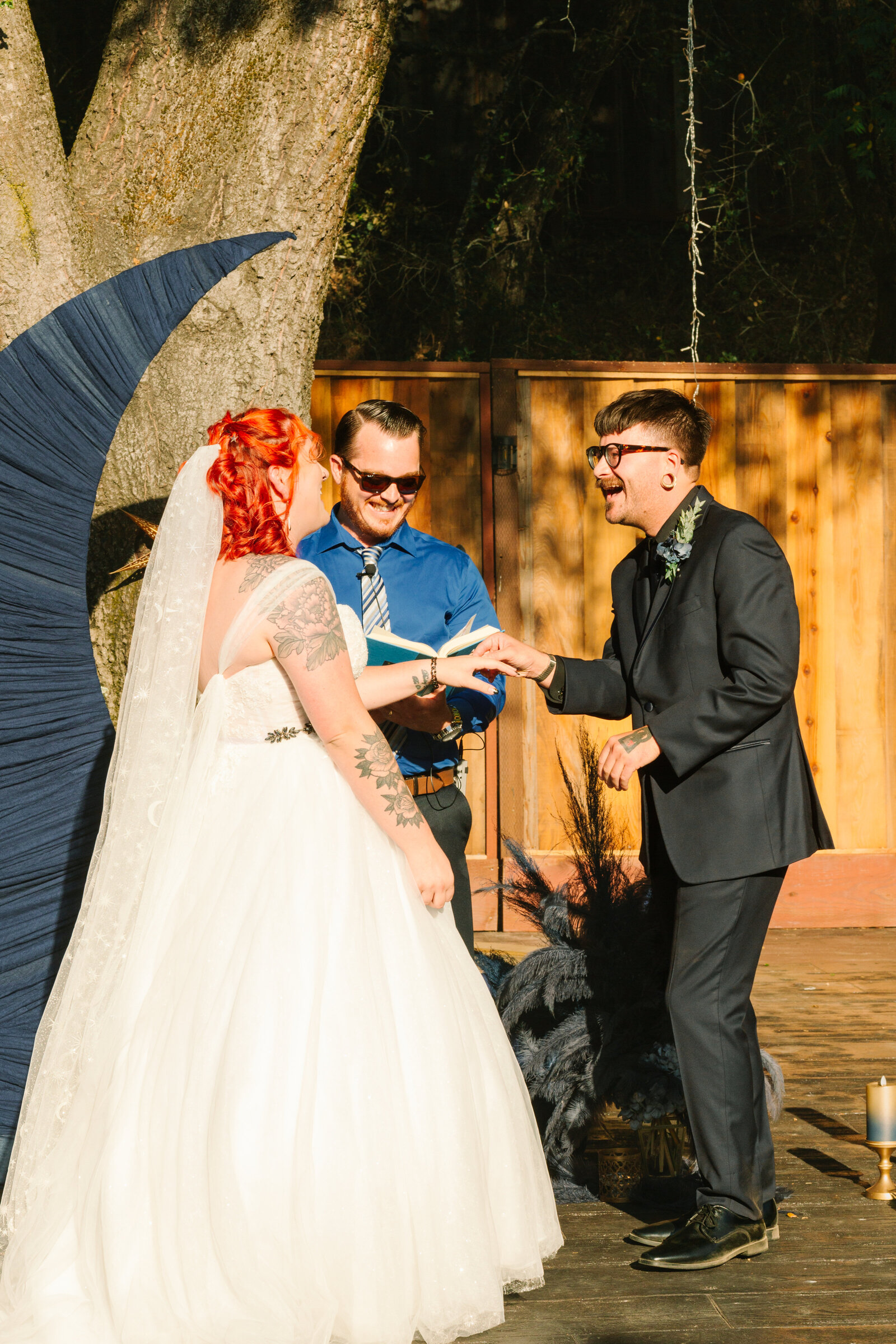 Ring exchange during a backyard California wedding.