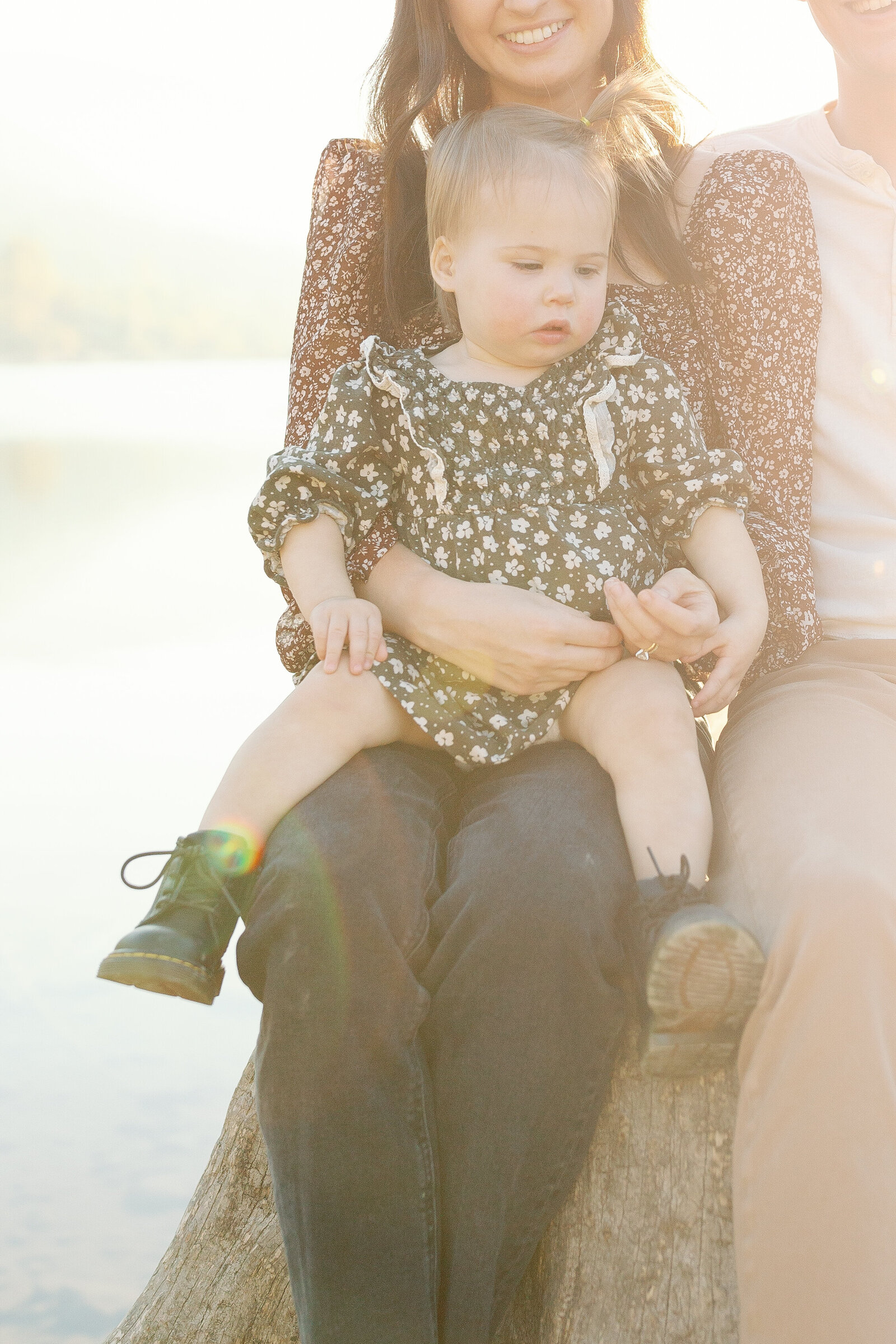 Baby girl sitting on tree stump at golden hour at Rattlesnake Lake in North Bend, Washington.