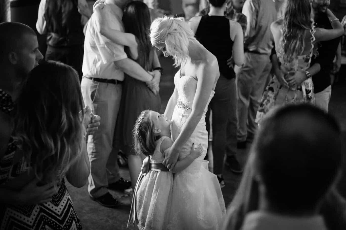 A bride and flower girl share a dance during her Catholic wedding in Northern Virginia