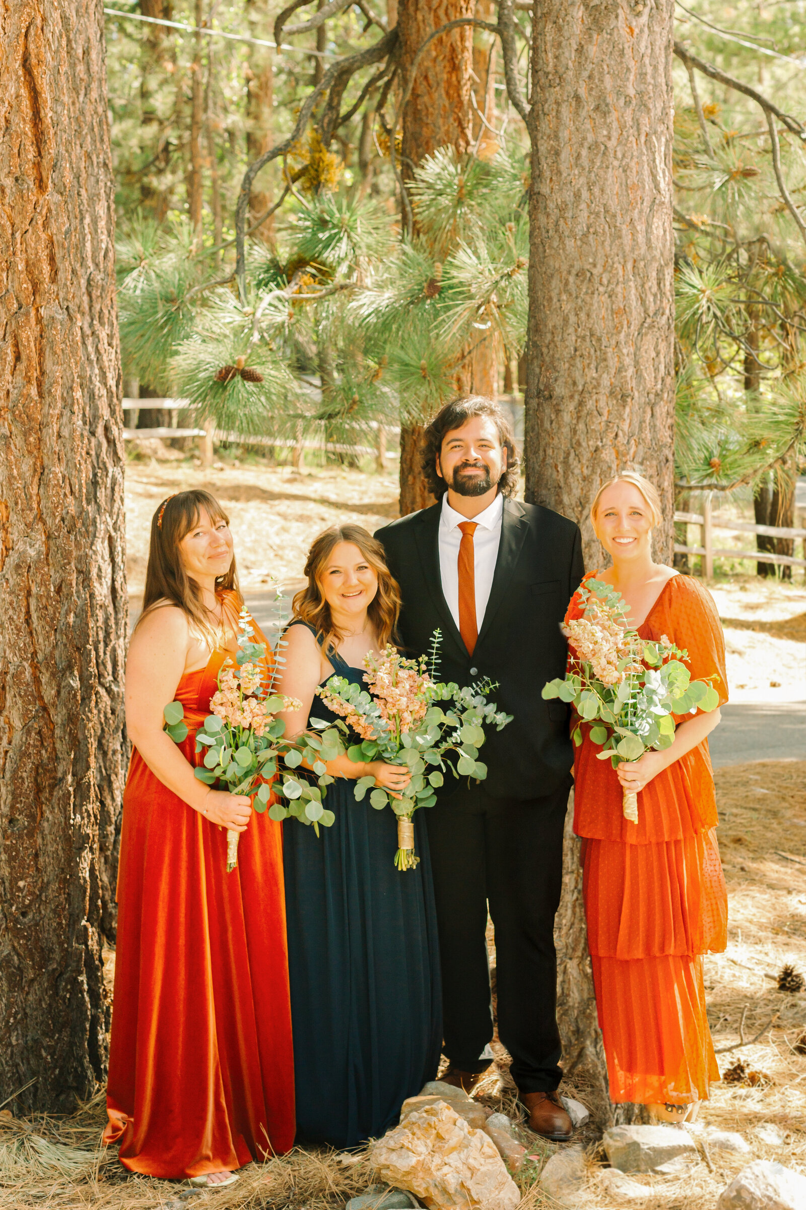 The bridal party celebrates an intimate elopement at a cabin at Big Bear Lake, California.