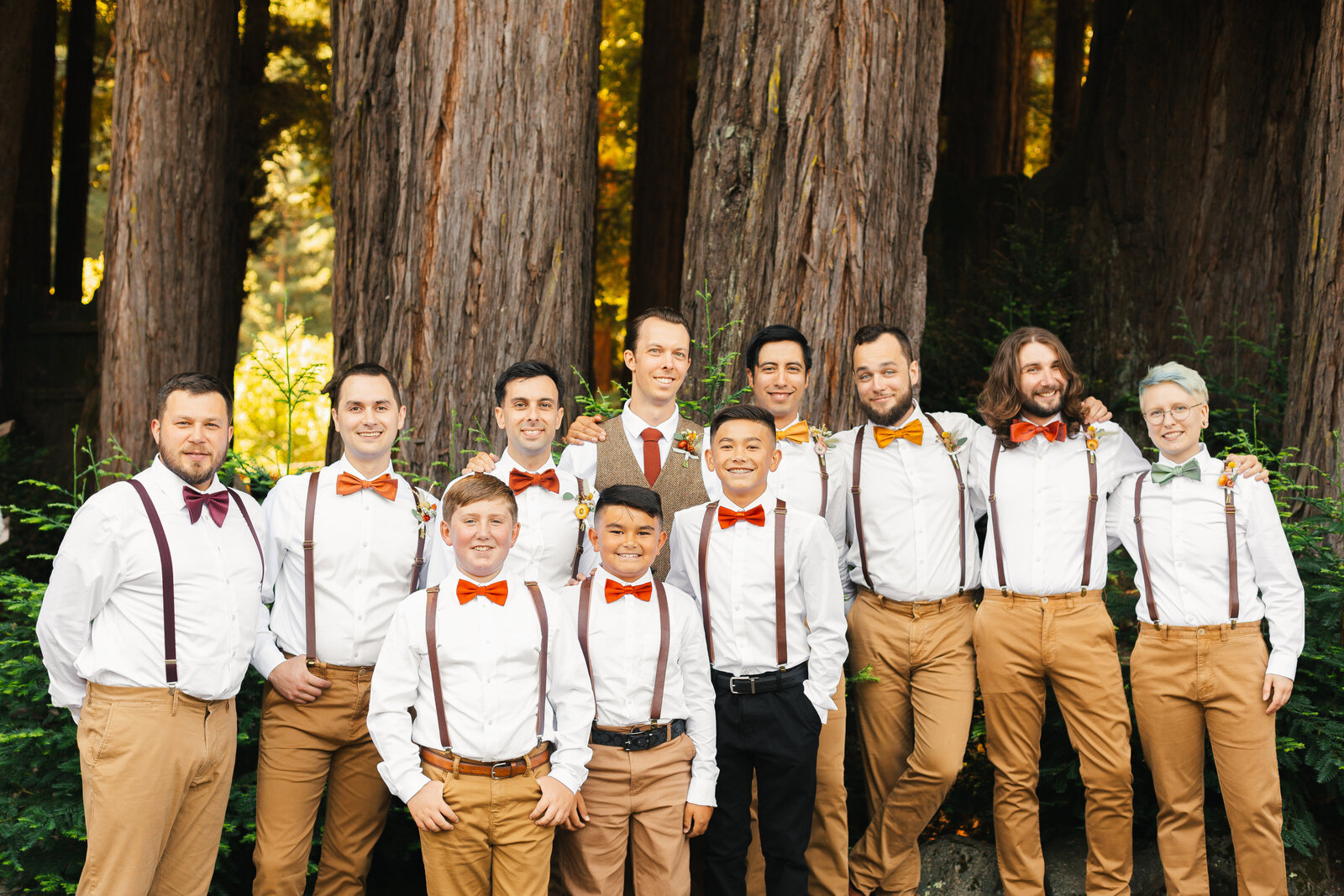 Bridal party at a colorful wedding ceremony in Santa Cruz, California in the redwood trees.