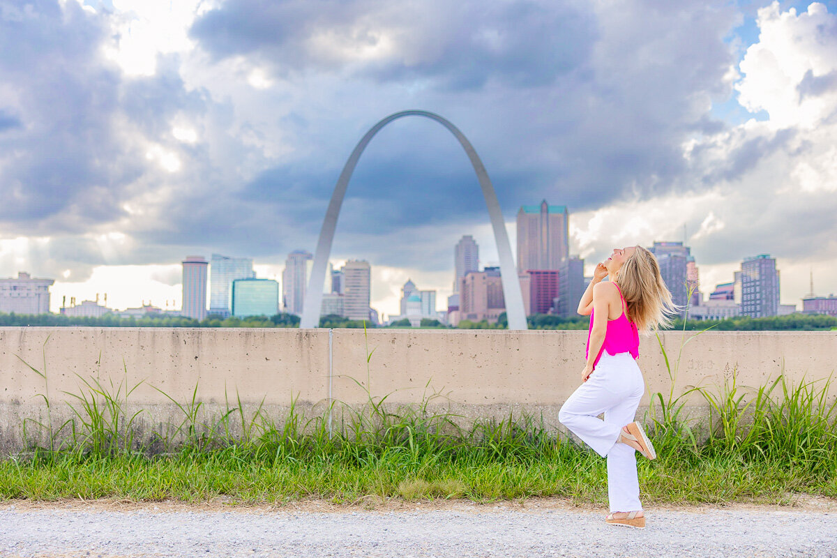 Marin with the arch and St. Louis sky line behind her