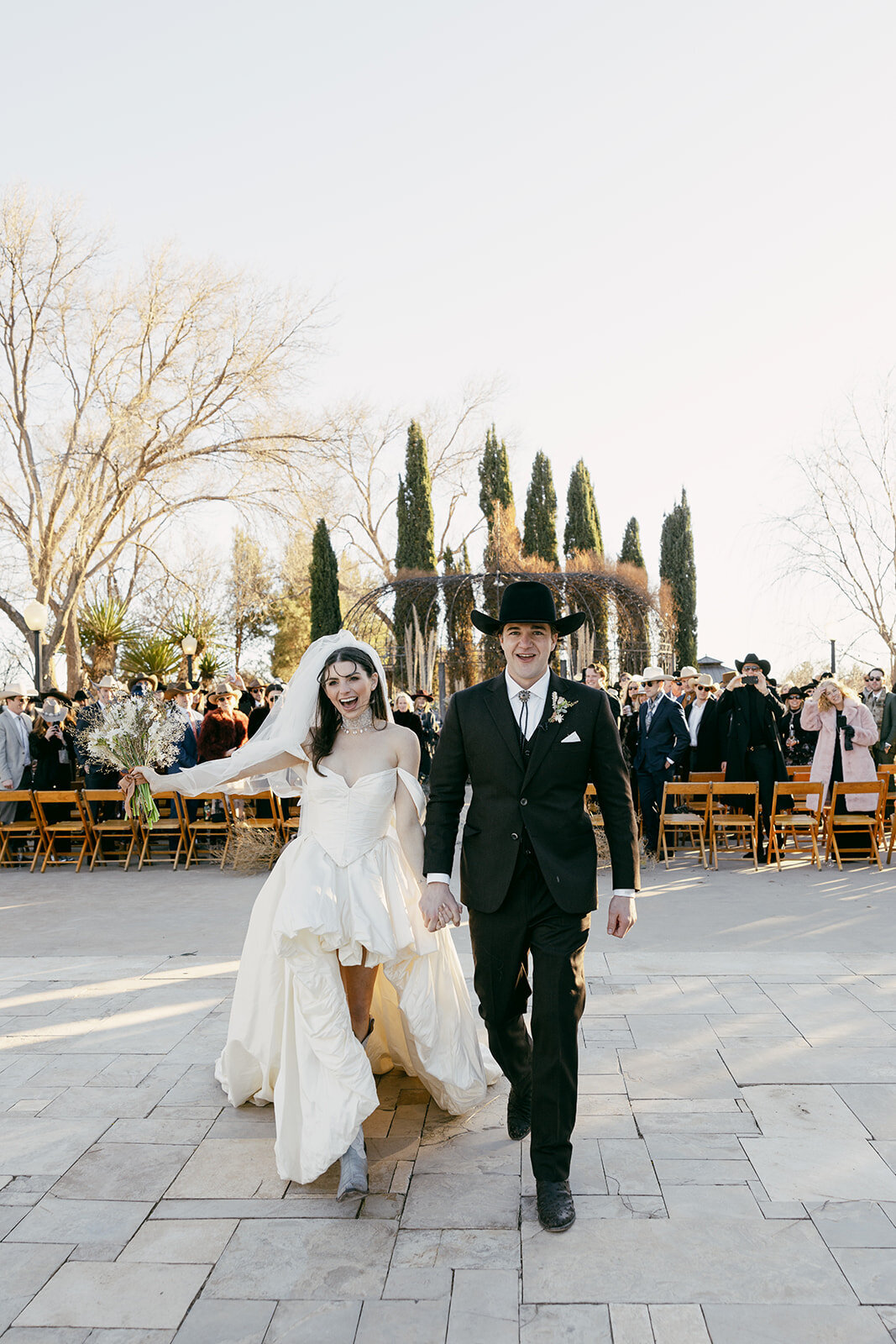 Bride and groom wearing cowboy boots