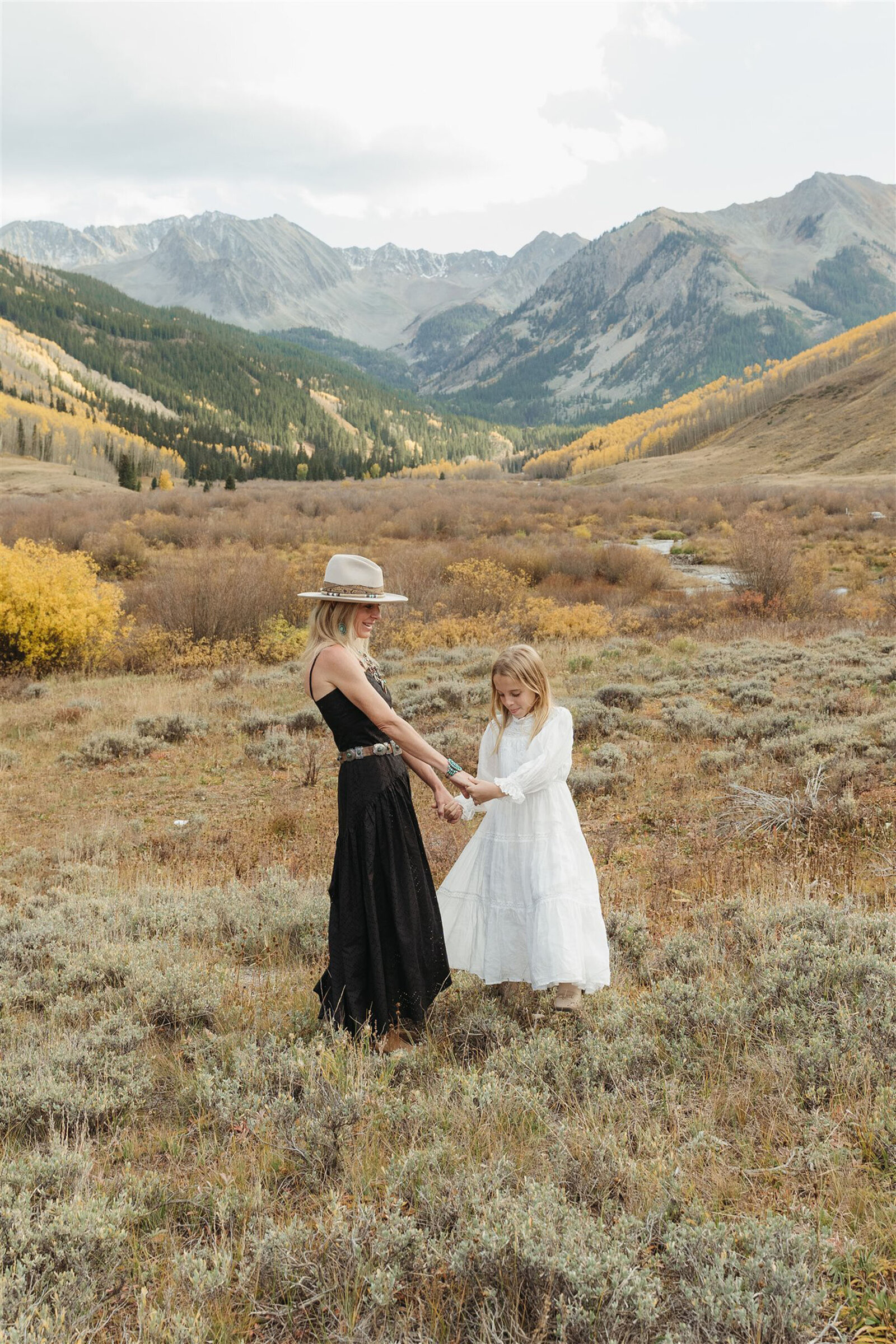Luxury Aspen family photography — the Stanley family styled in Ralph Lauren–inspired layers with the Rocky Mountains in the background.