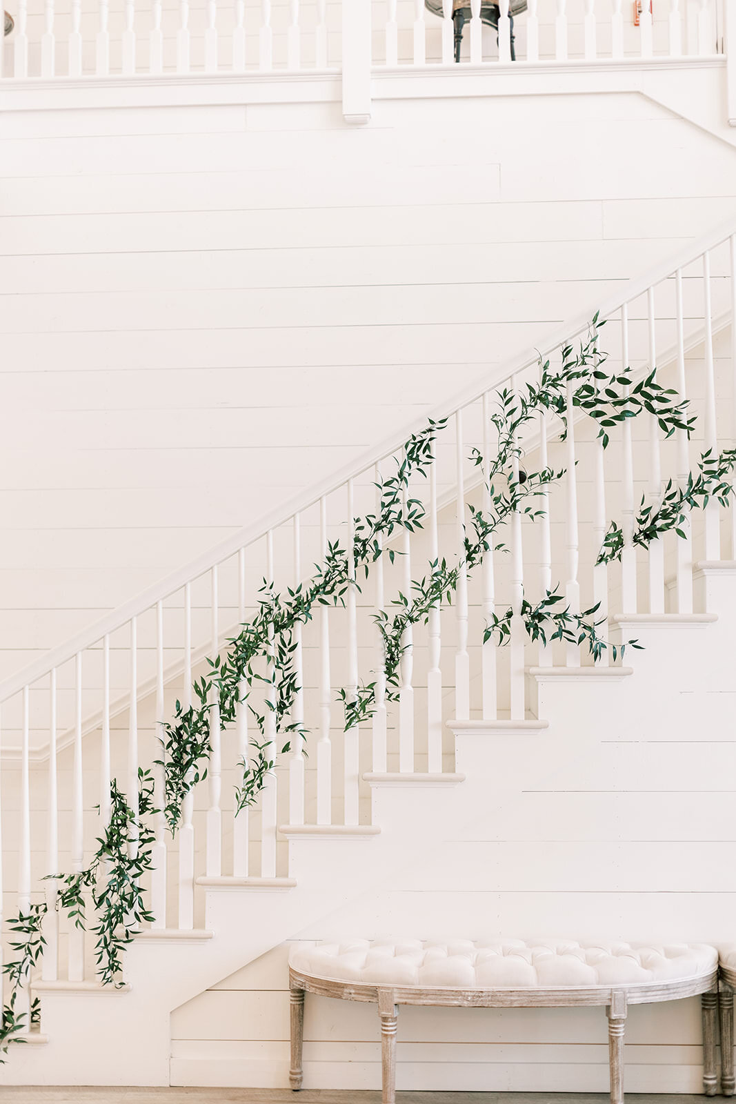 White stair case decorated with vines