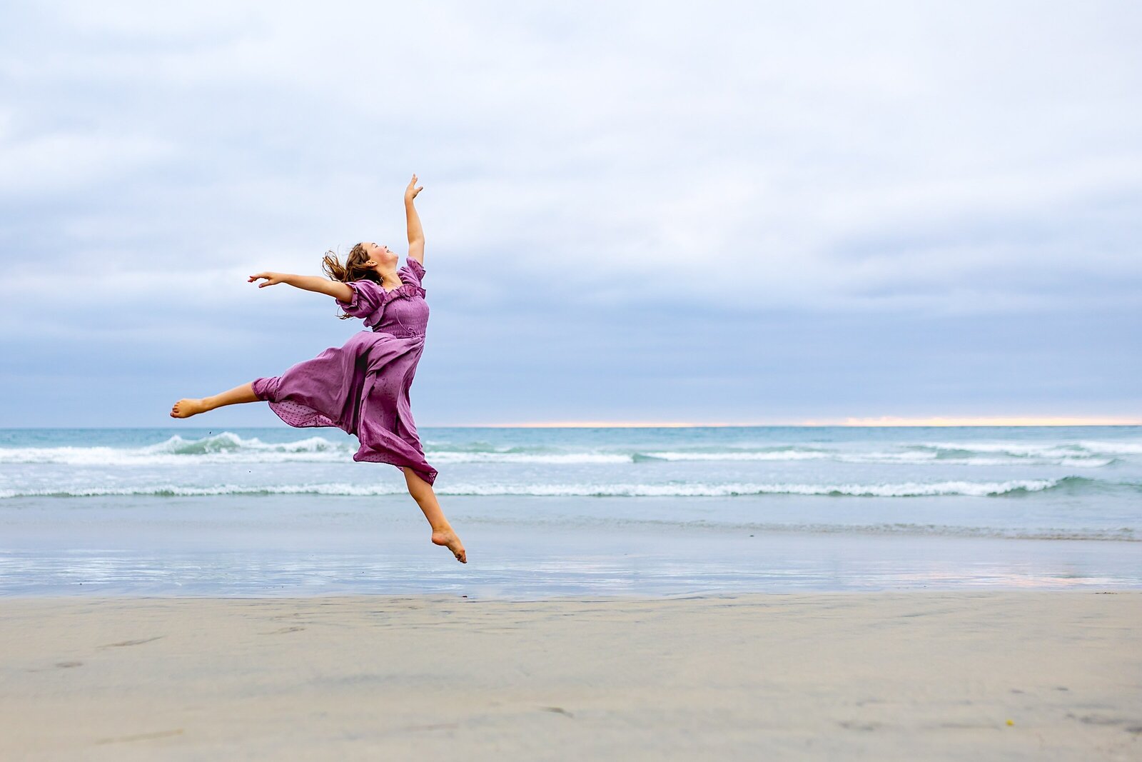 teen girl dancing on the beach