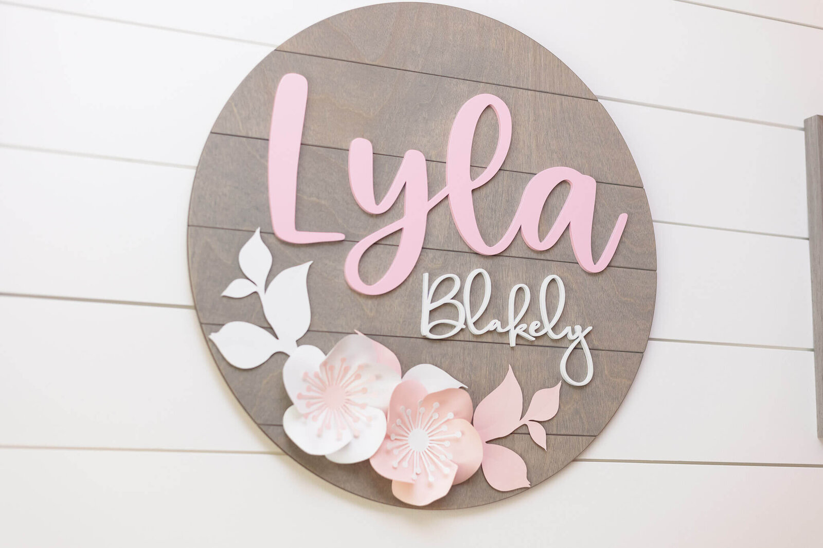 A close-up of decor with baby girl's name on it.