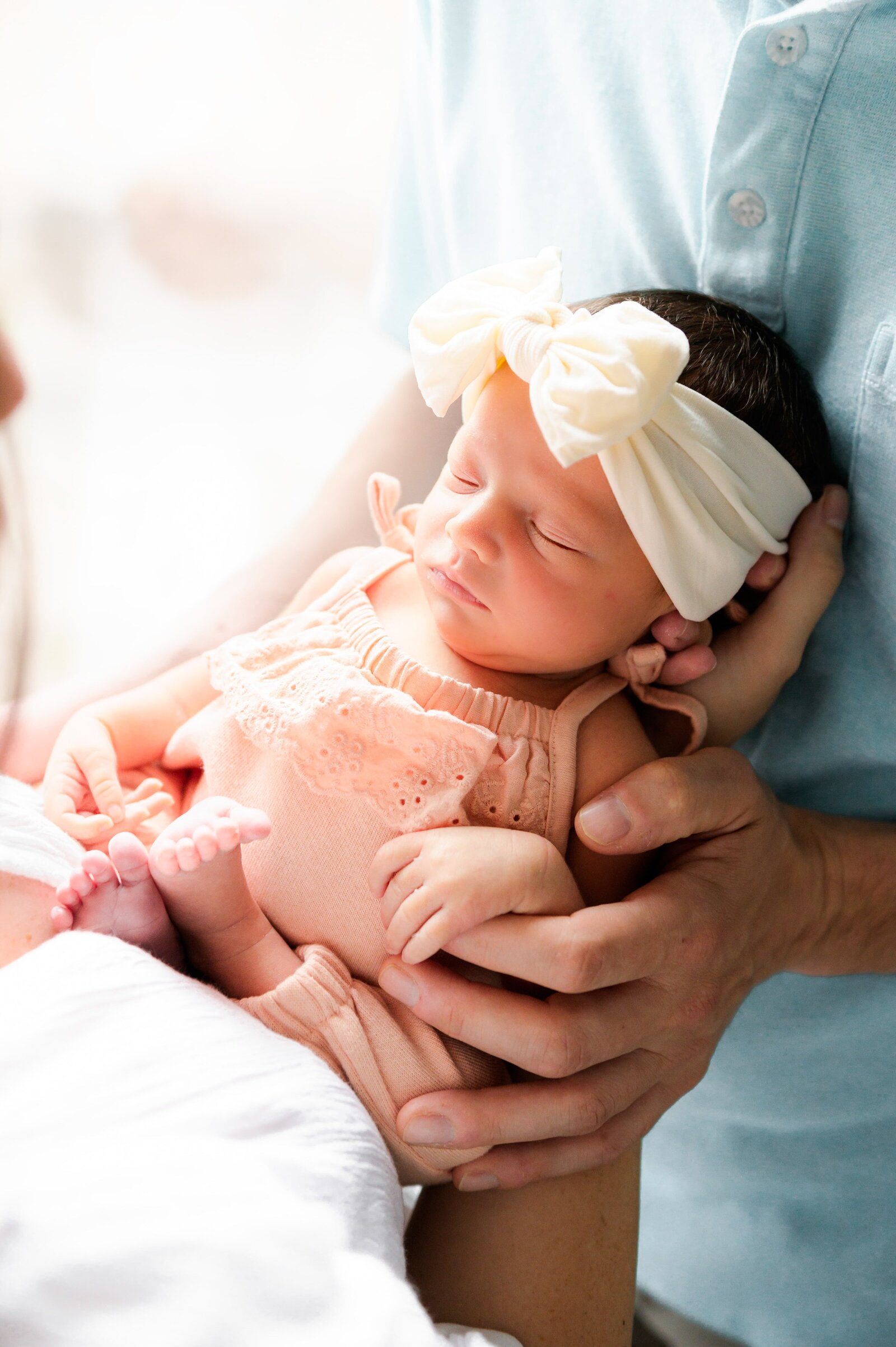 newborn baby girl in parents hands