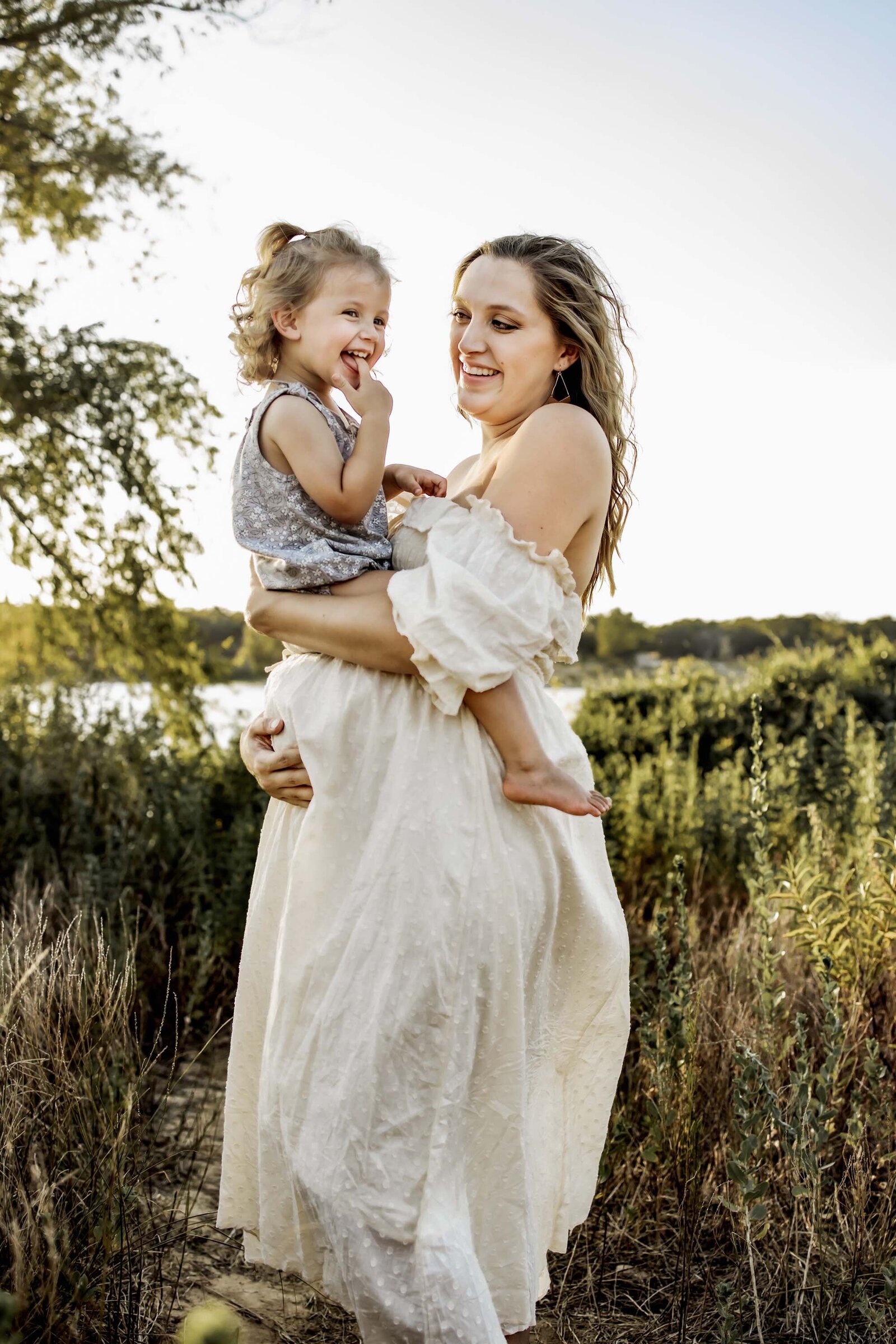 mom holding toddler on her pregnant belly Flower Mound Texas