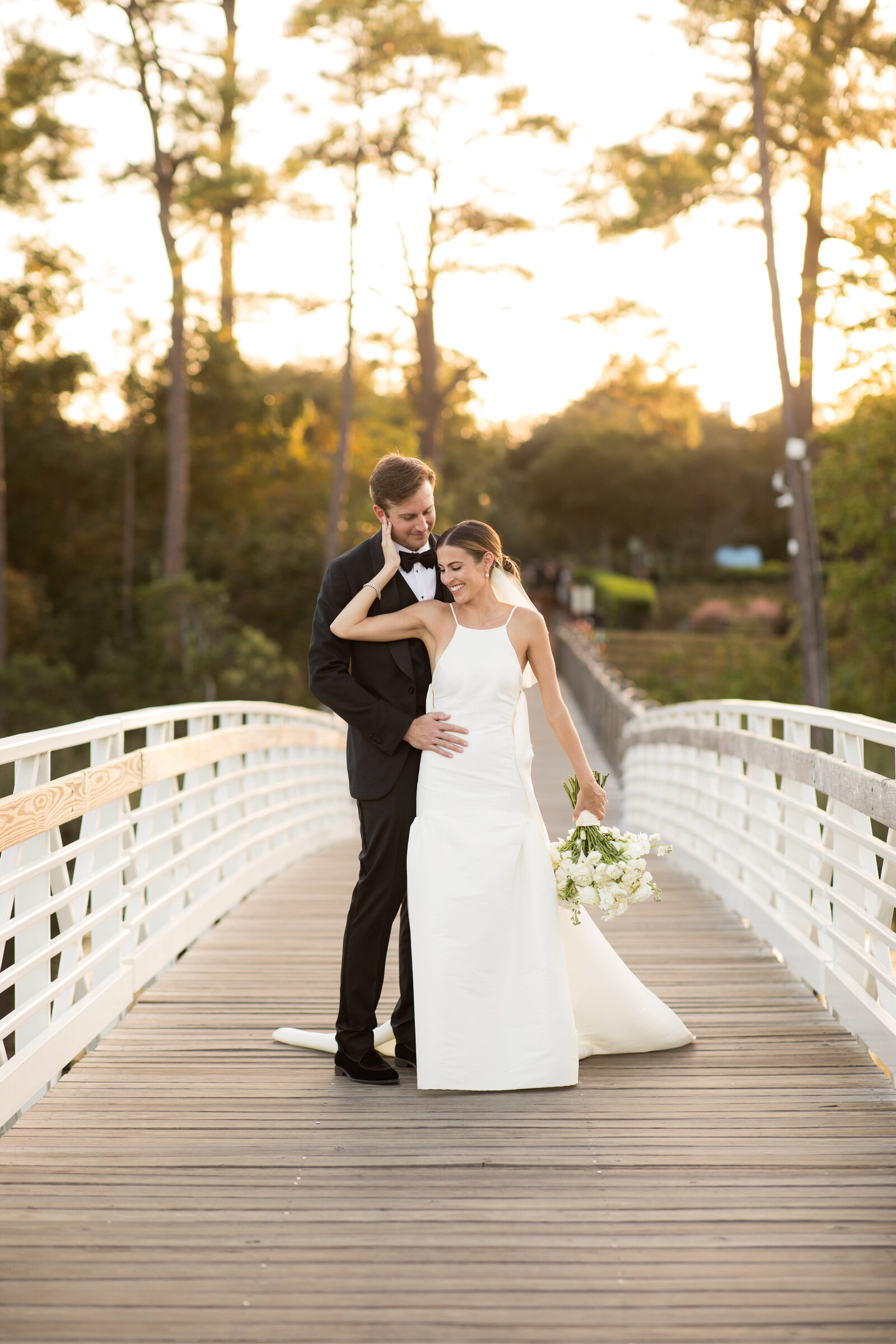 Beautiful shot of the couple at watercolor bride by the lakehouse