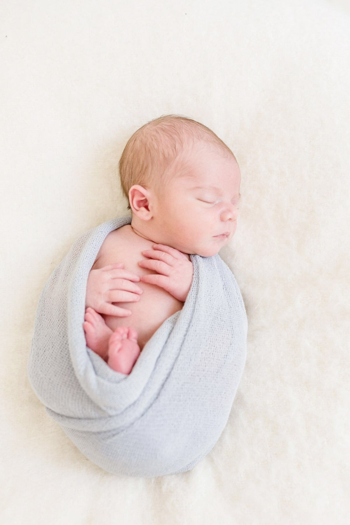 Newborn wrapped in blue
