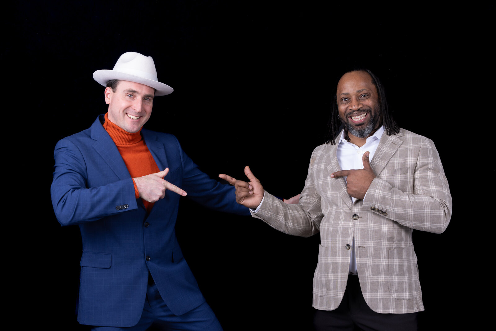 Charizma DJs Jimmy and Marz laughing and striking playful pose in colorful suits